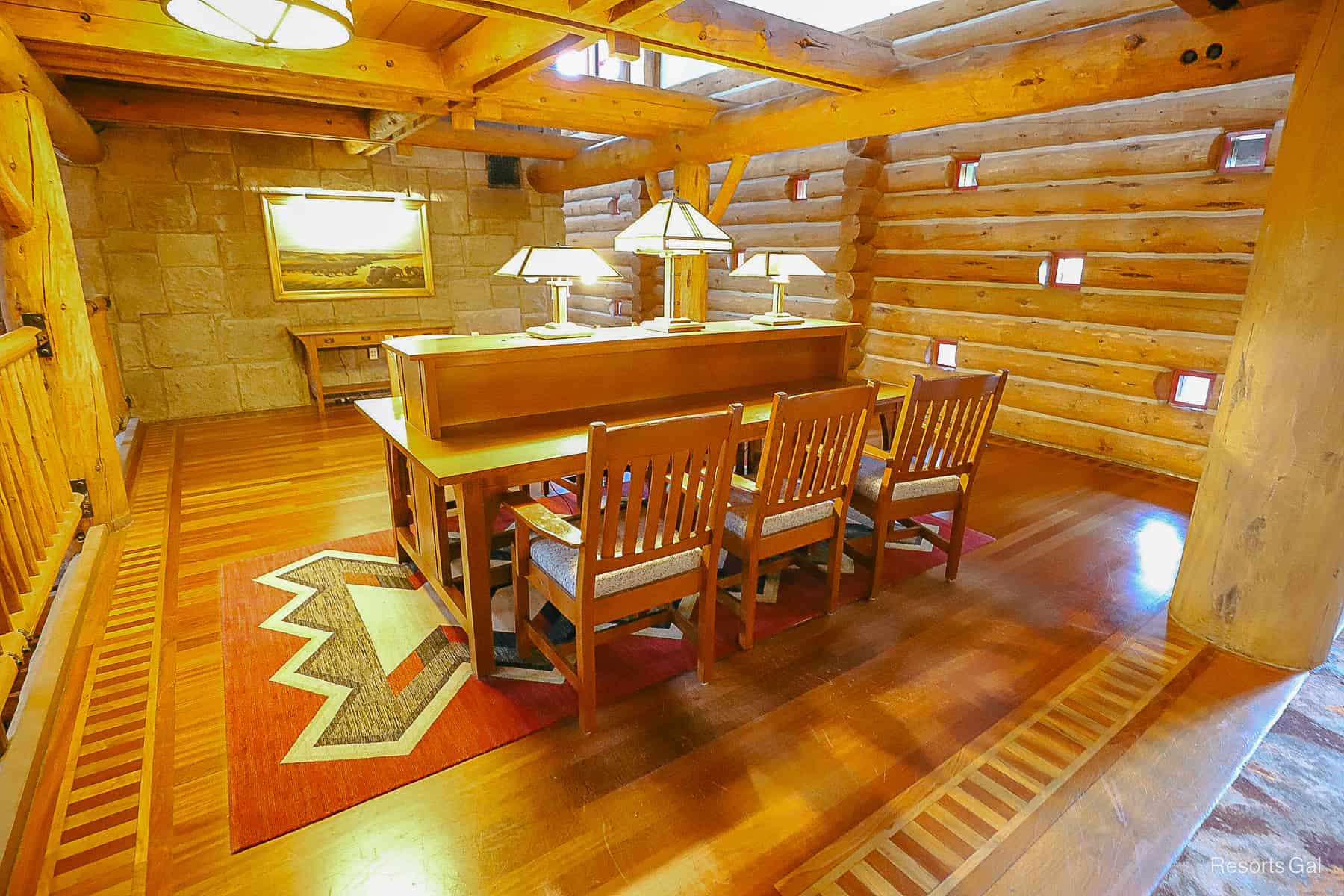 a long desk with chairs for guests to use on an upper level floor of the lobby 