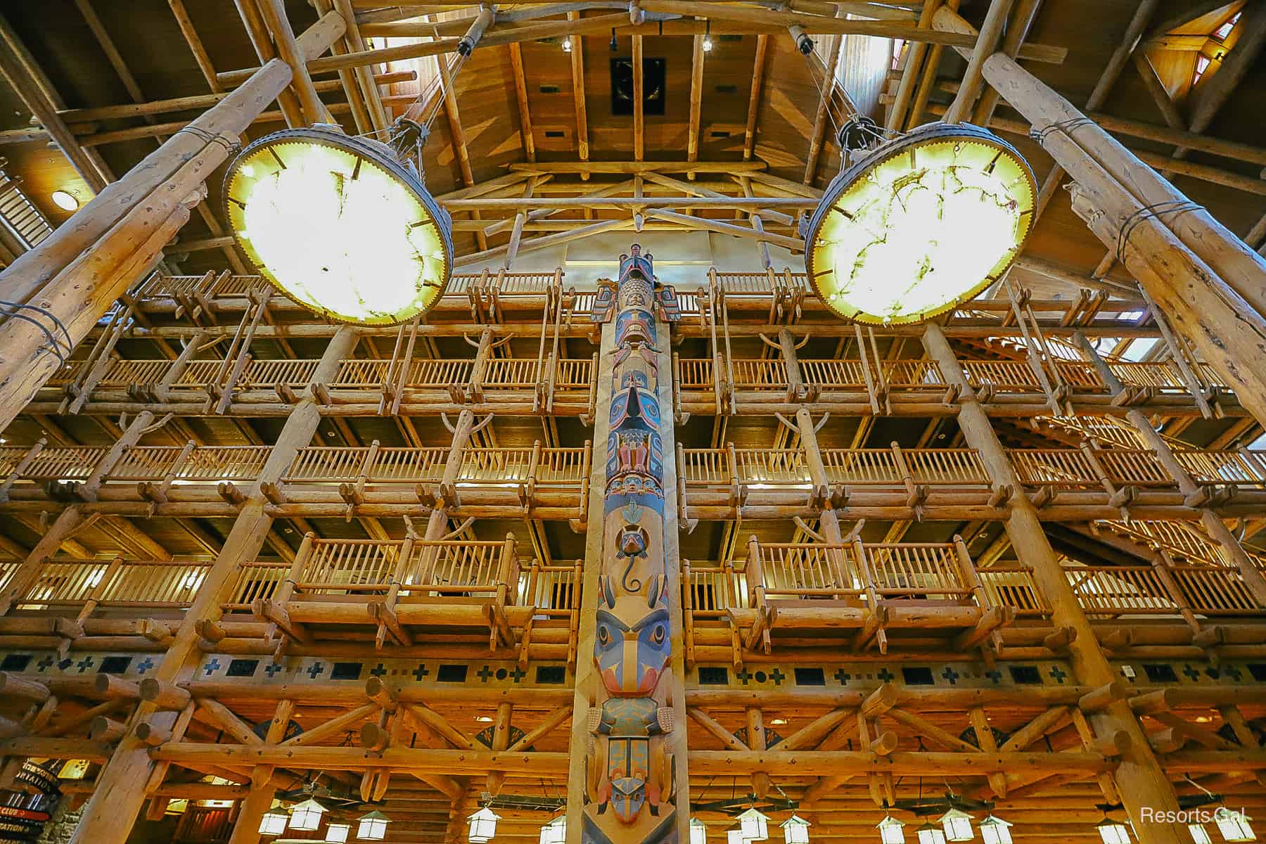 two large light fixtures with a totem pole between them 