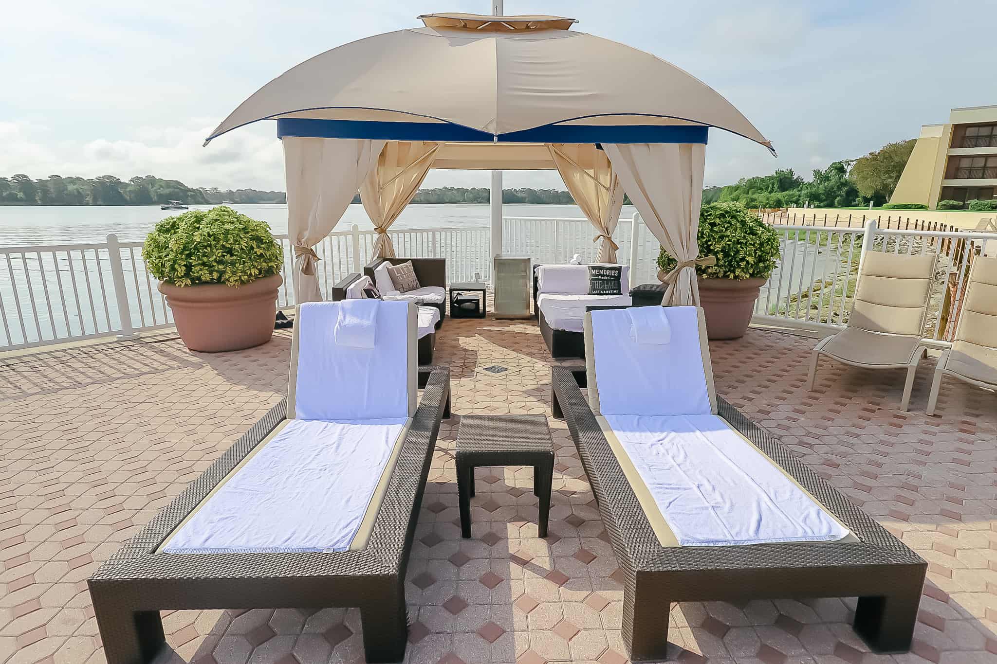 Two lounge chairs that sit in front of the cabana at the Bay Lake Pool. 