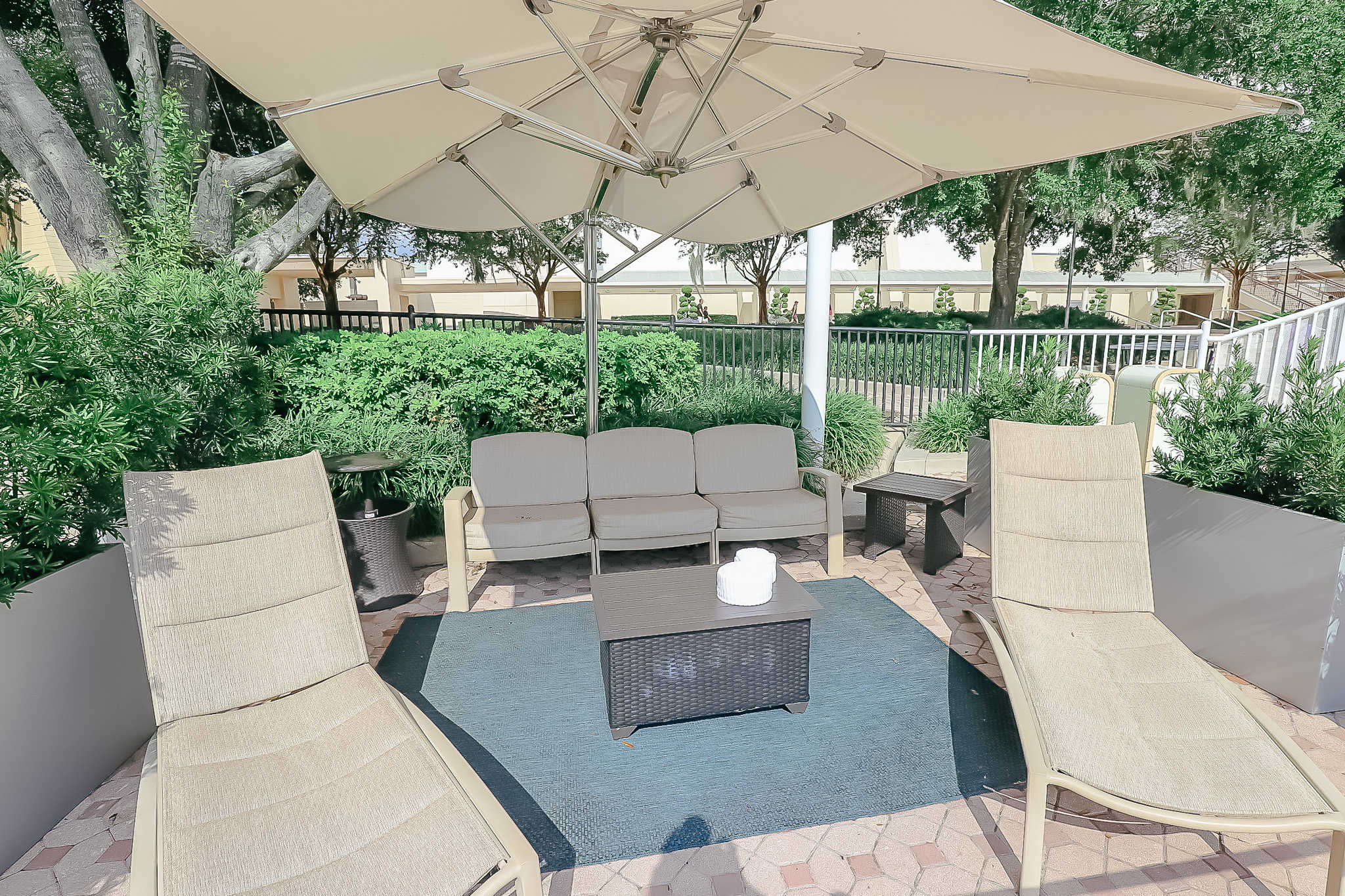 two lounge chairs with a patio couch and umbrella 