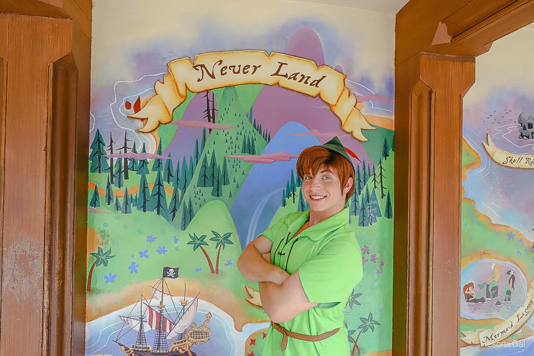 Peter Pan poses in front of the Never Land map at Magic Kingdom. 