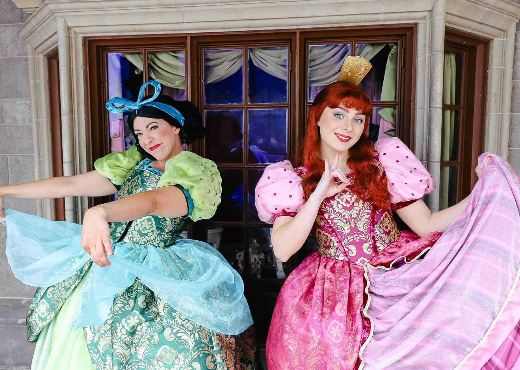 Anastasia wearing her pink dress and Drizella wearing her green dress. 