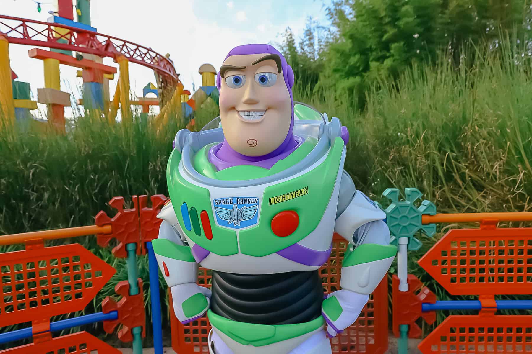 Buzz Lightyear poses in front of the fence at Toy Story Land. 
