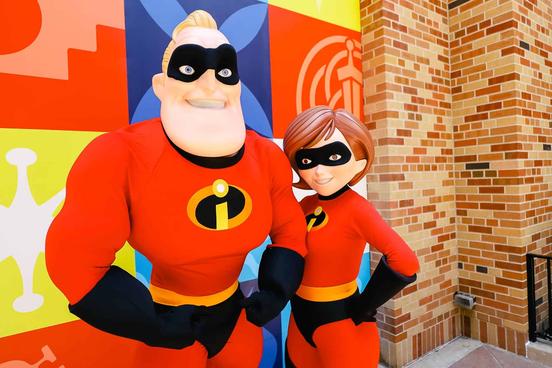 Mr. and Mrs. Incredible with a Pixar backdrop. 