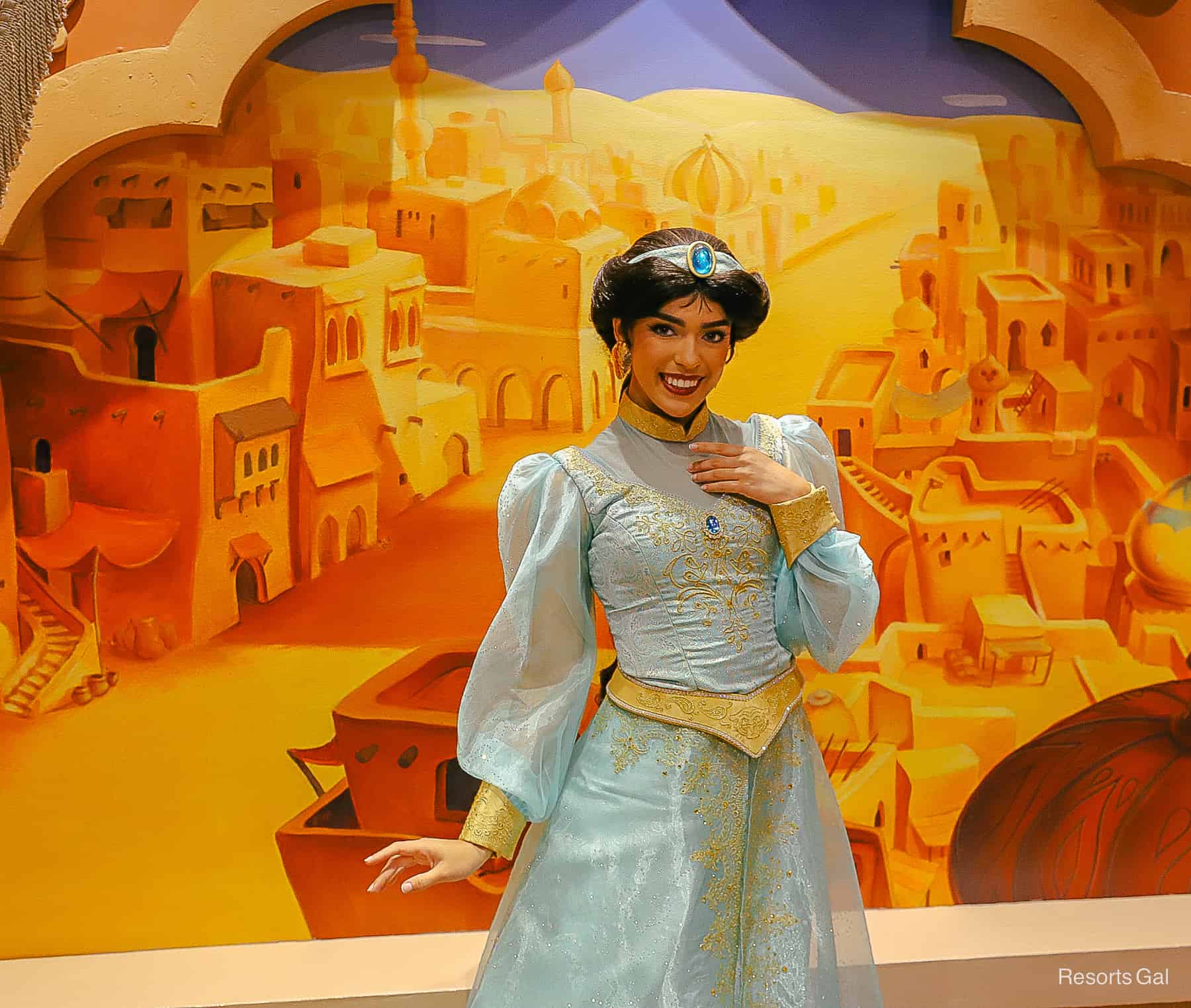 Jasmine meets in front of a scene featuring the city of Agrabah at Epcot. 