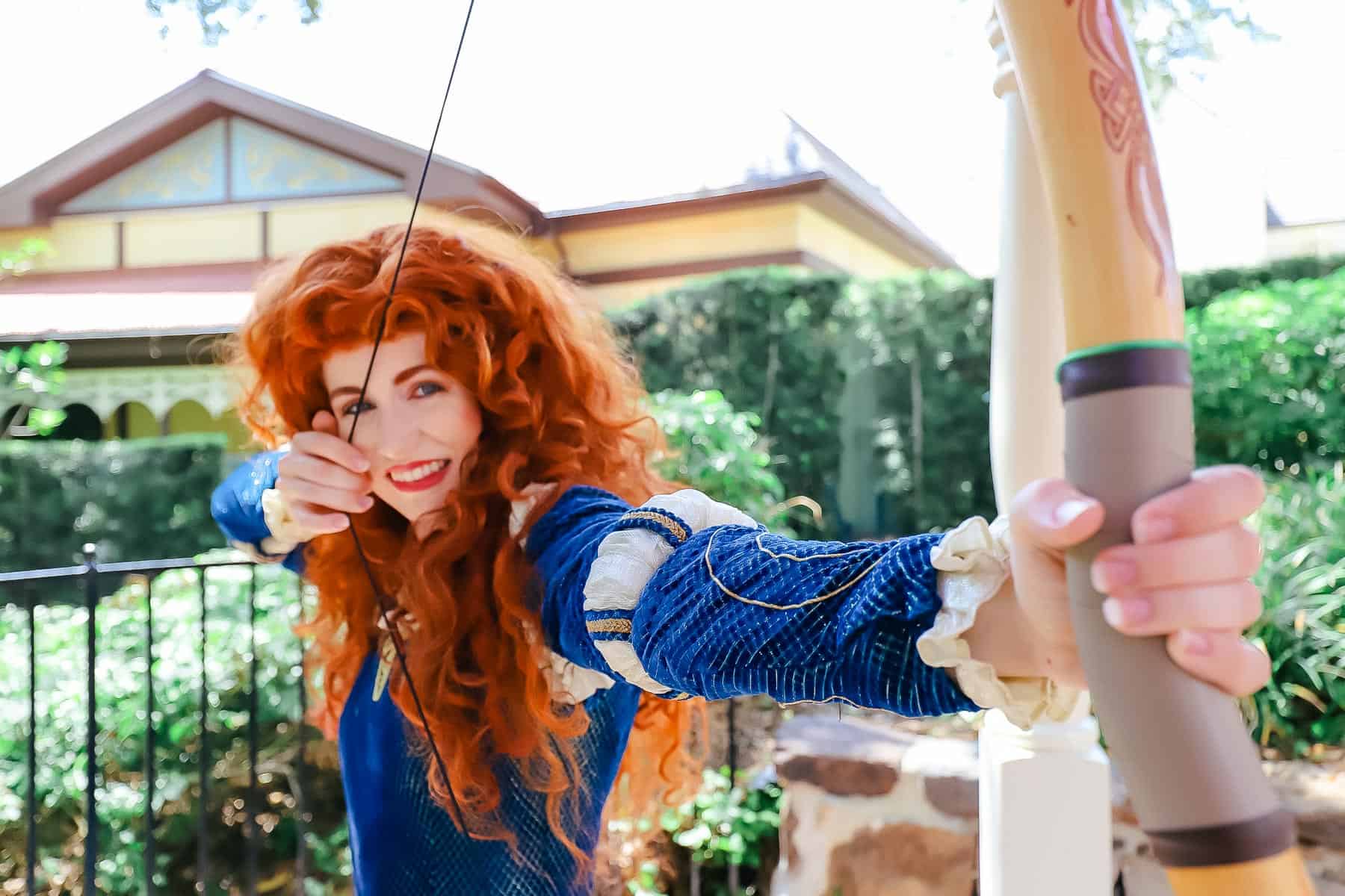 Merida with her bow drawn at Magic Kingdom. 