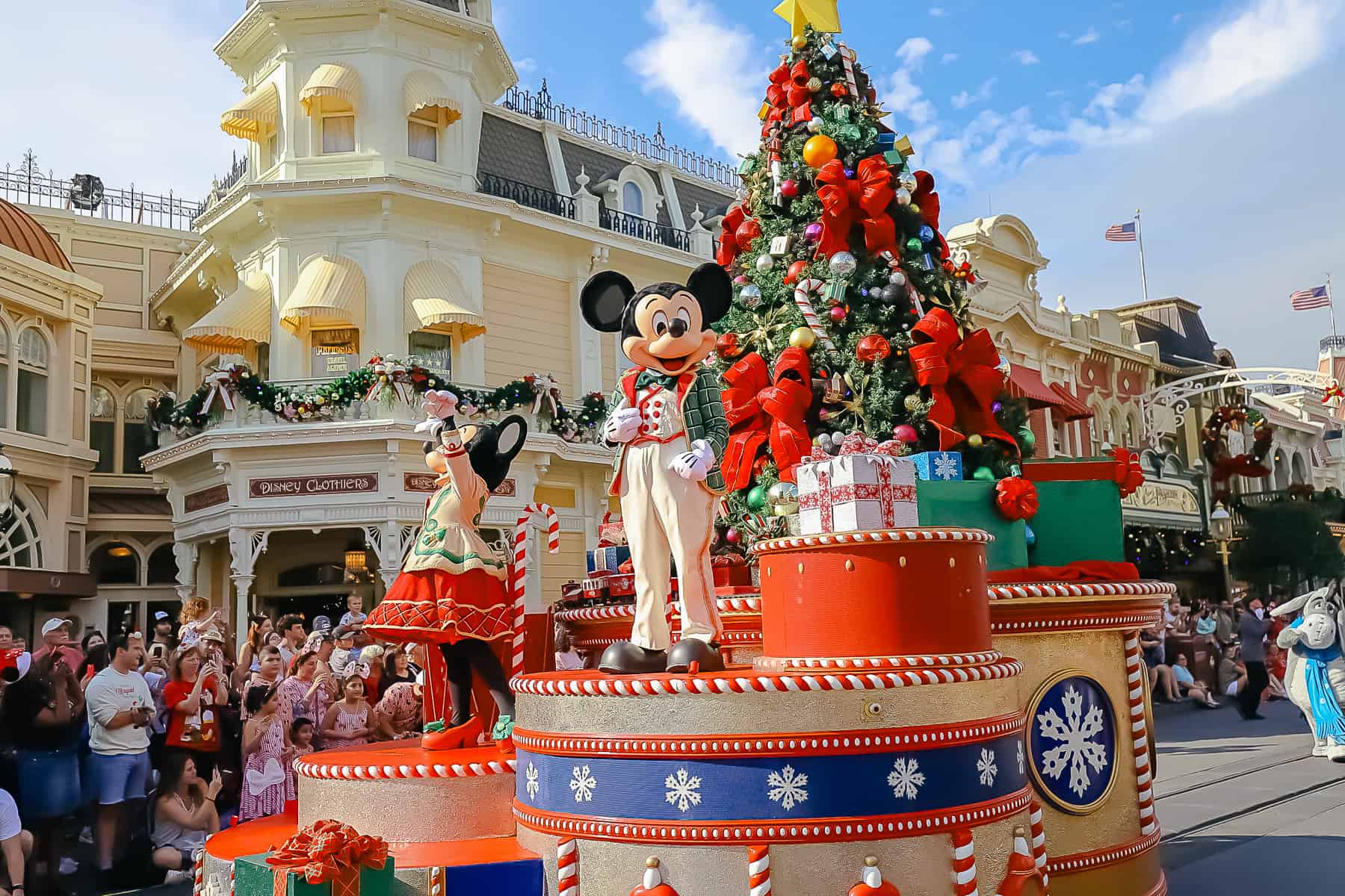 Mickey and Minnie with float details, including a Christmas tree, presents, and miniature train set. 