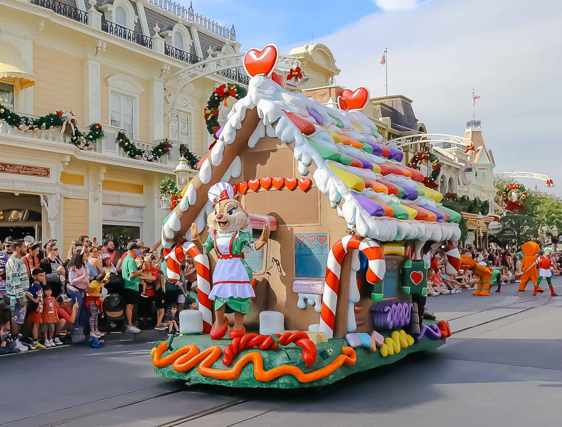 Clarice rides at the front of the gingerbread float. 