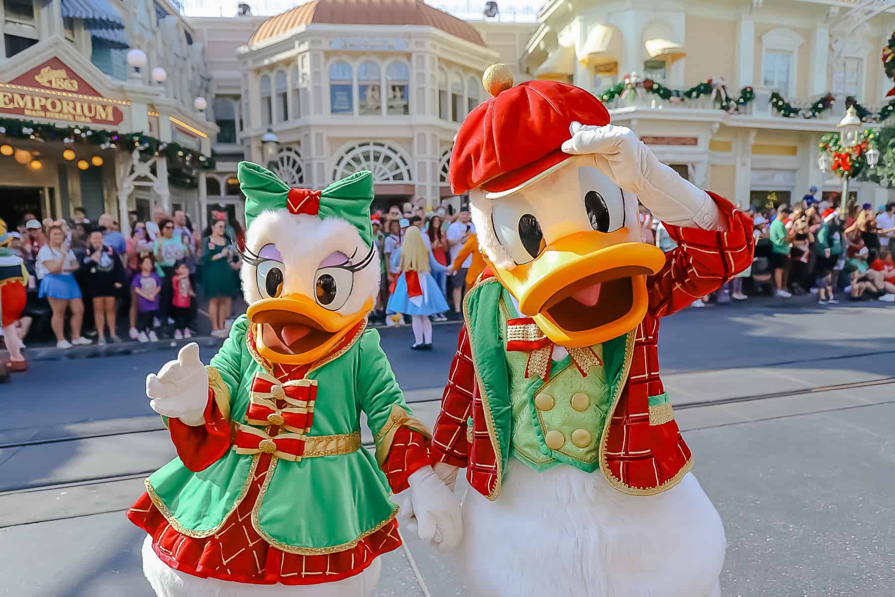 Donald tipping his hat in the parade with Daisy at his side. 