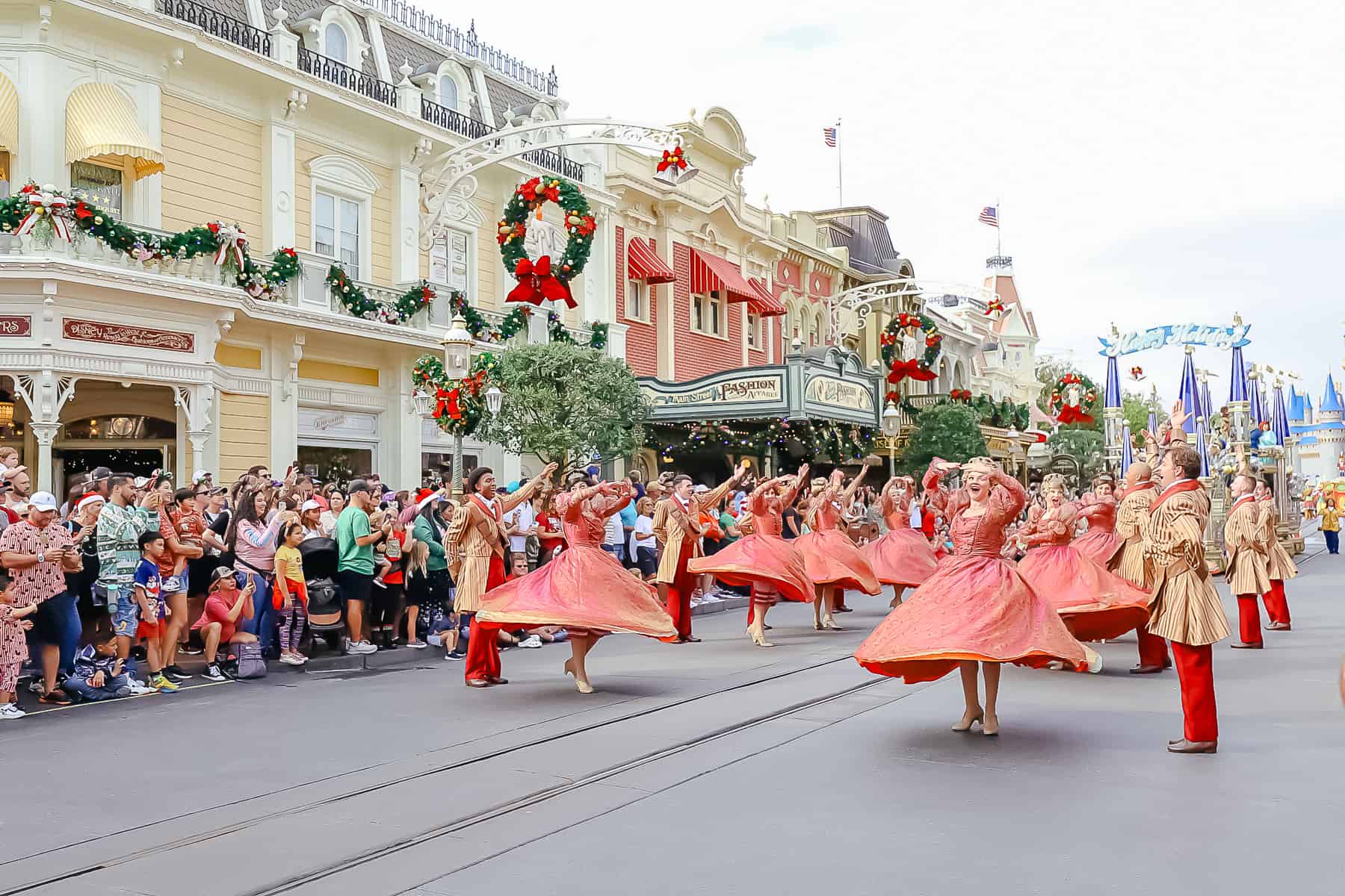 Ballroom dancers twirling their skirts before the Princess float. 