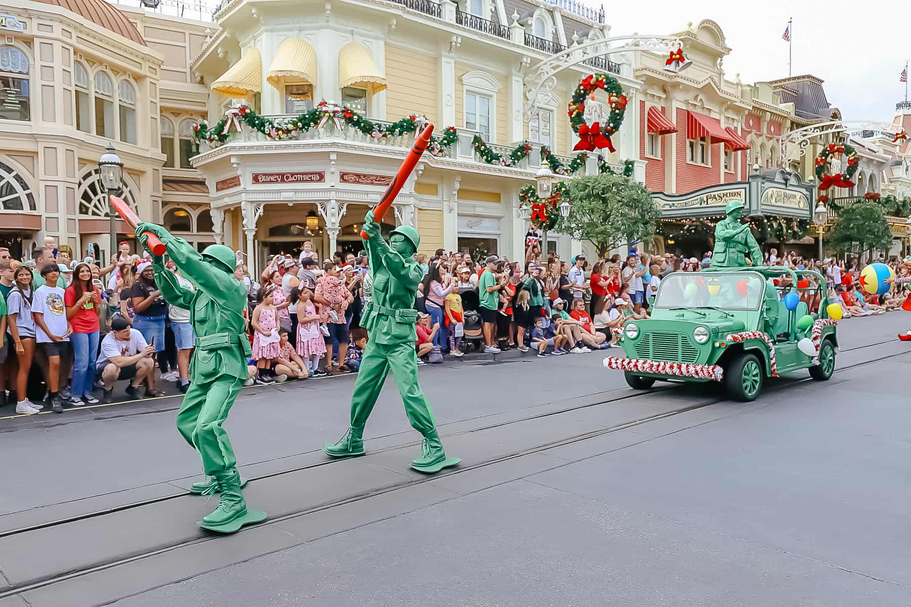 Green army men carrying giant red crayons. 