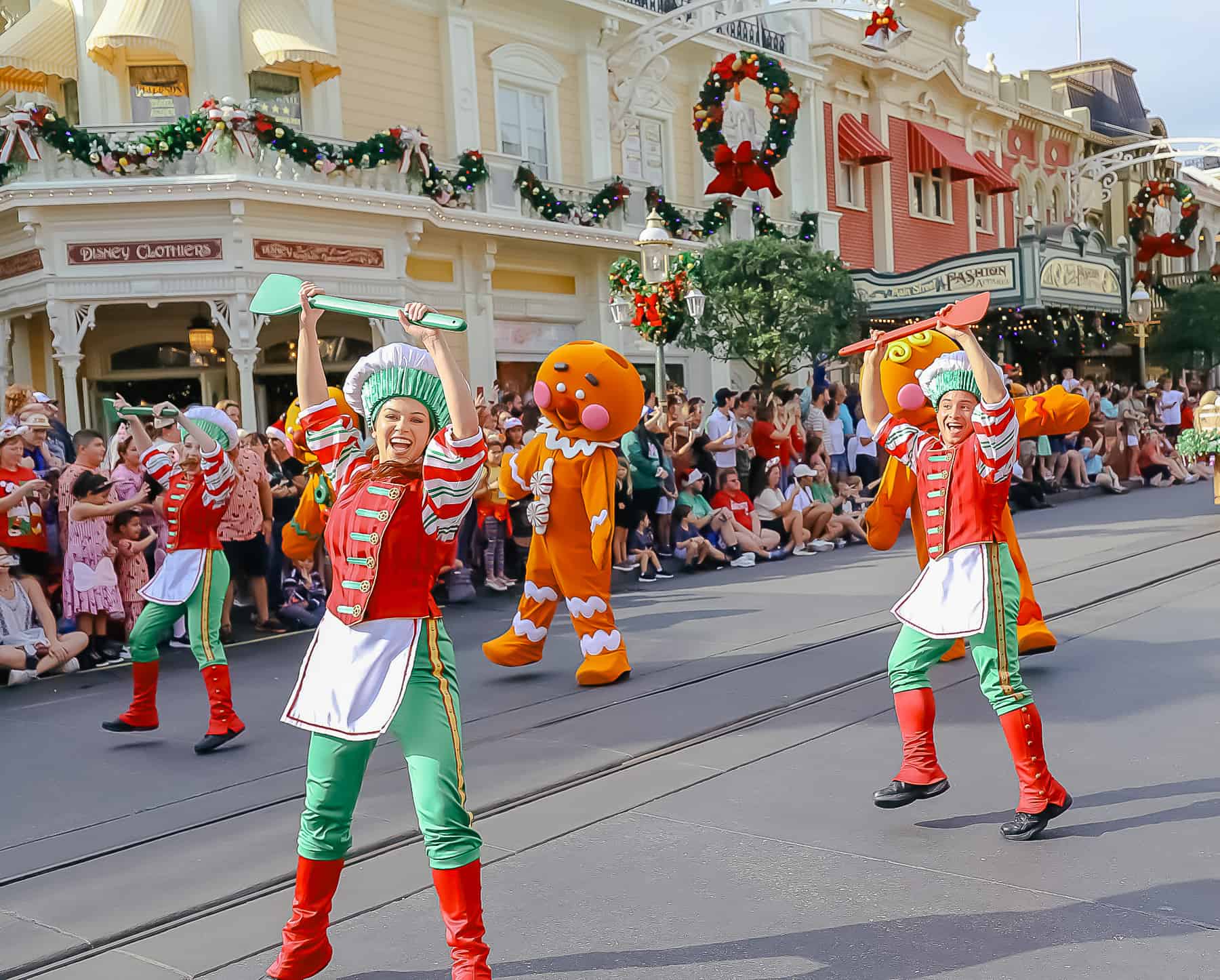 Dancers in chef's outfits with oversized spatulas.