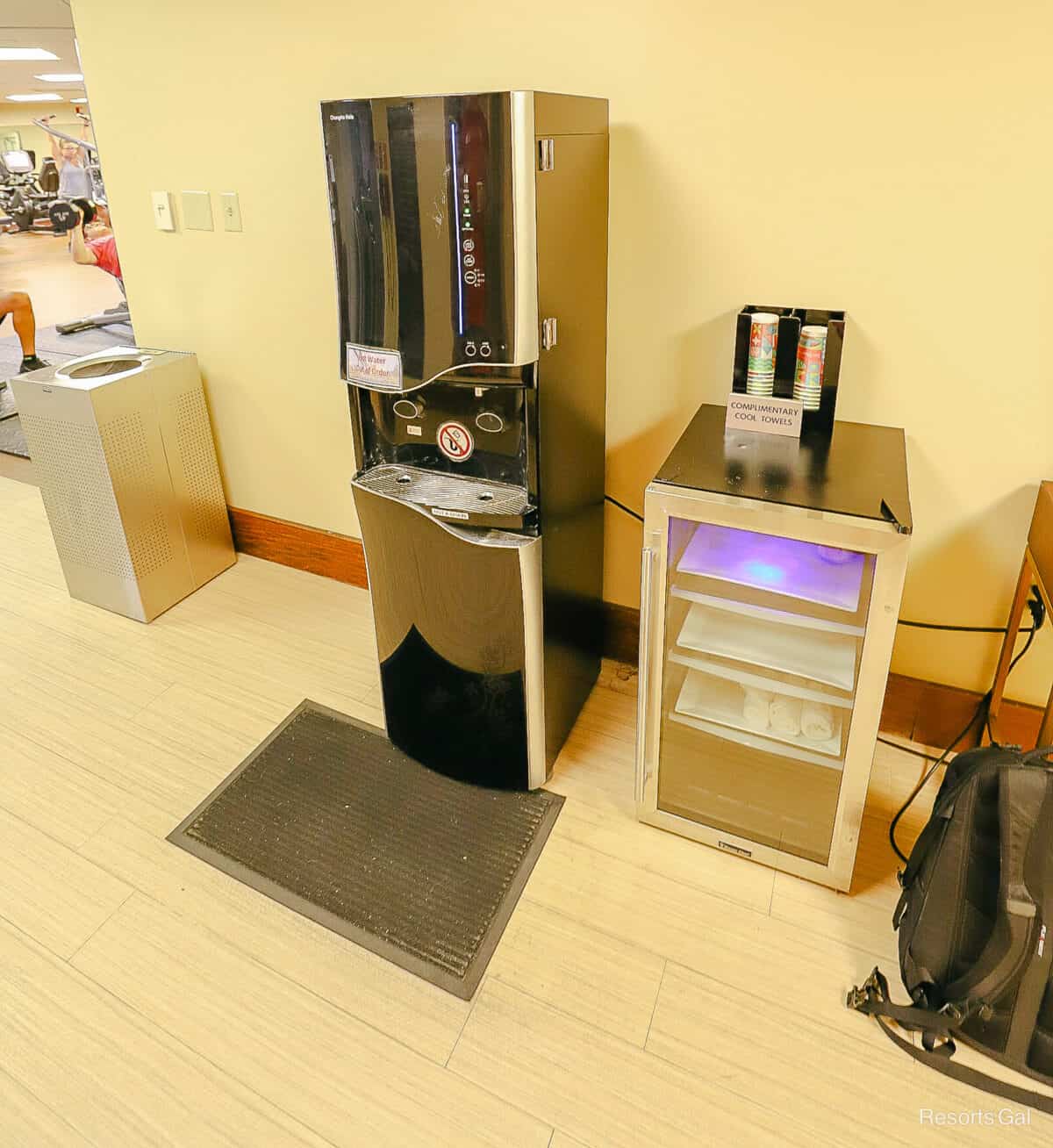 a machine with filtered water, complimentary cups, and cool towels in a Disney Resort Hotel Gym 