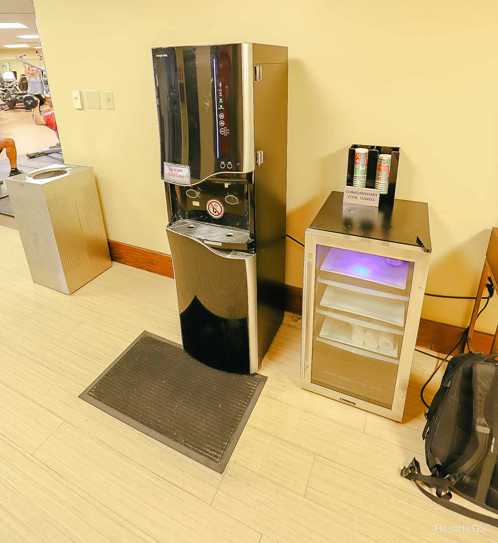 a machine with filtered water, complimentary cups, and cool towels in a Disney Resort Hotel Gym