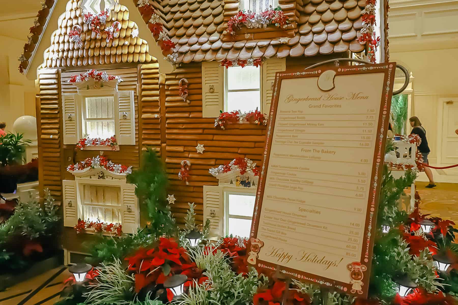 Shows the gingerbread house with a list of ingredients. 