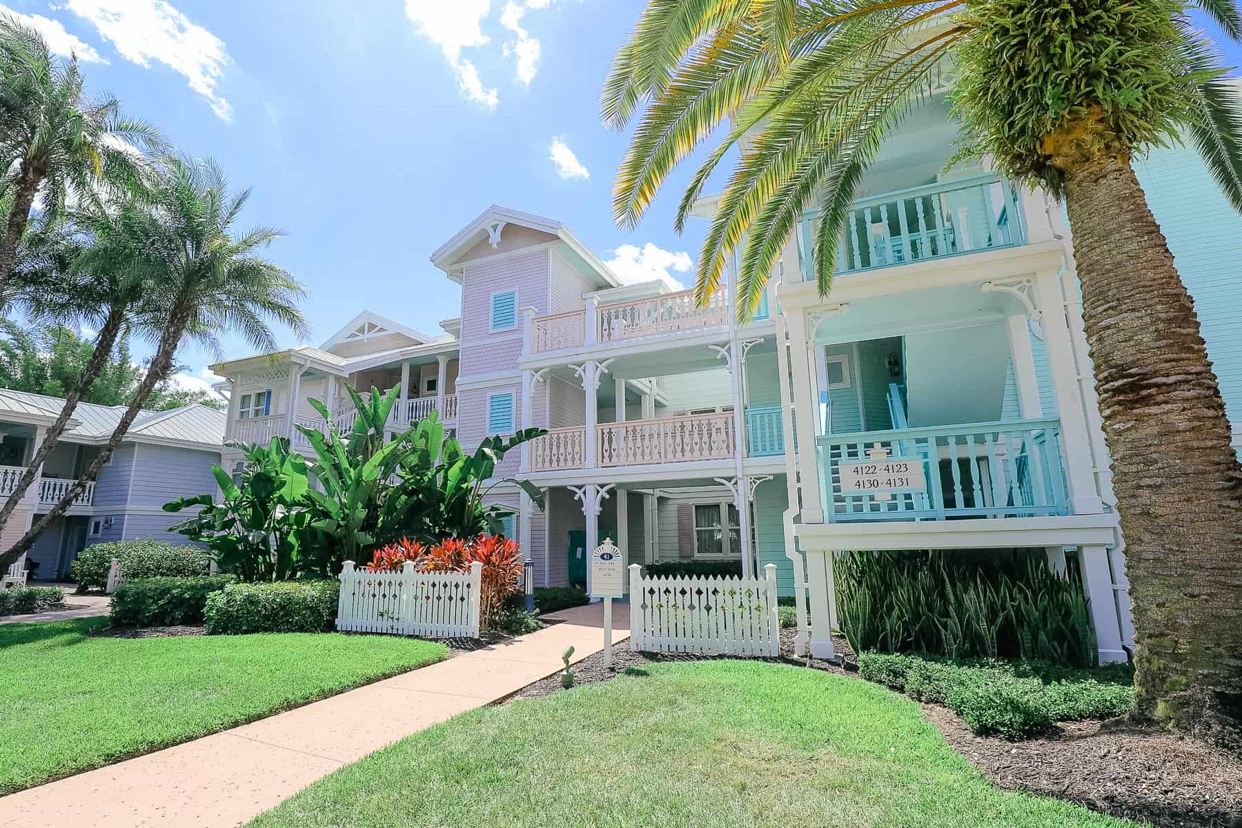Old Key West exterior with staircases in pink and mint green colors. 