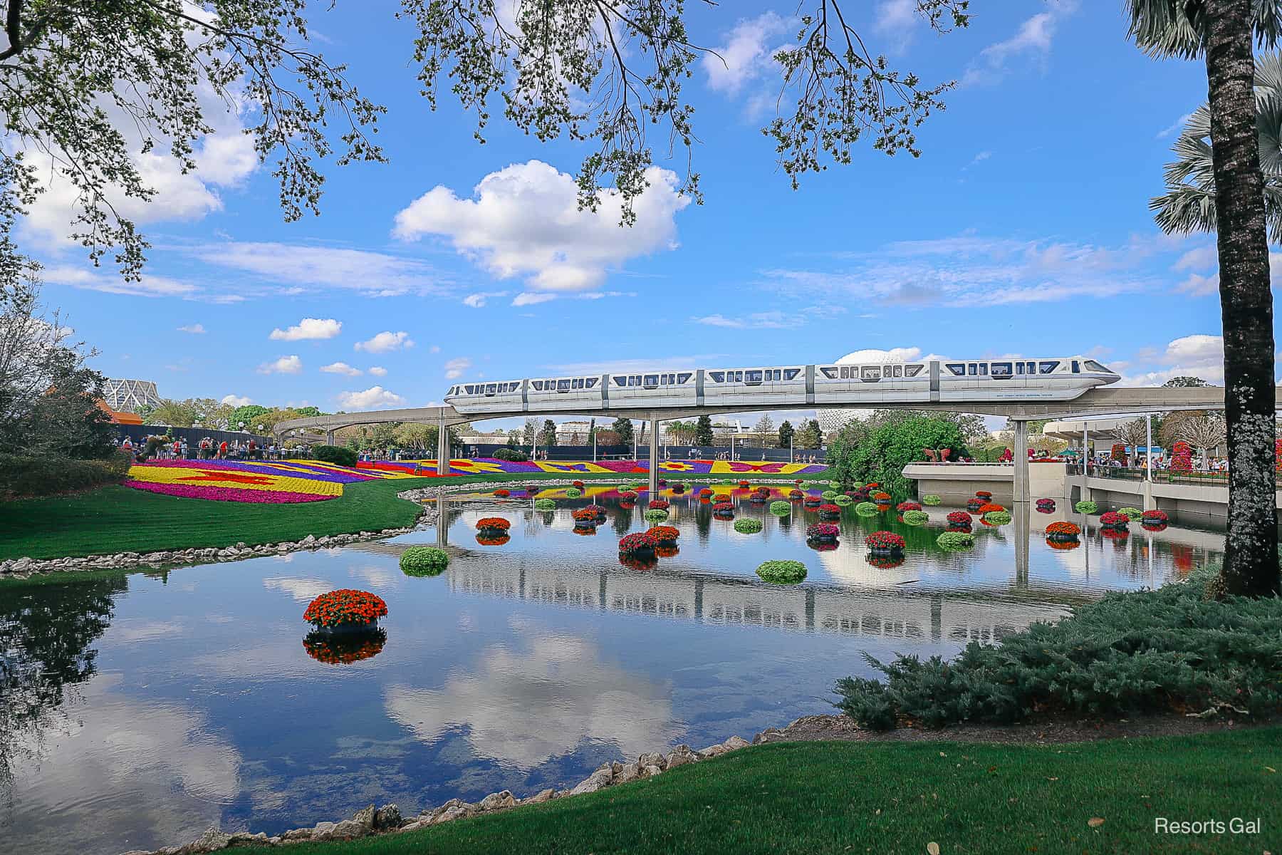 The Disney World monorail with a scenic backdrop at Epcot during the Flower and Garden Festival. 