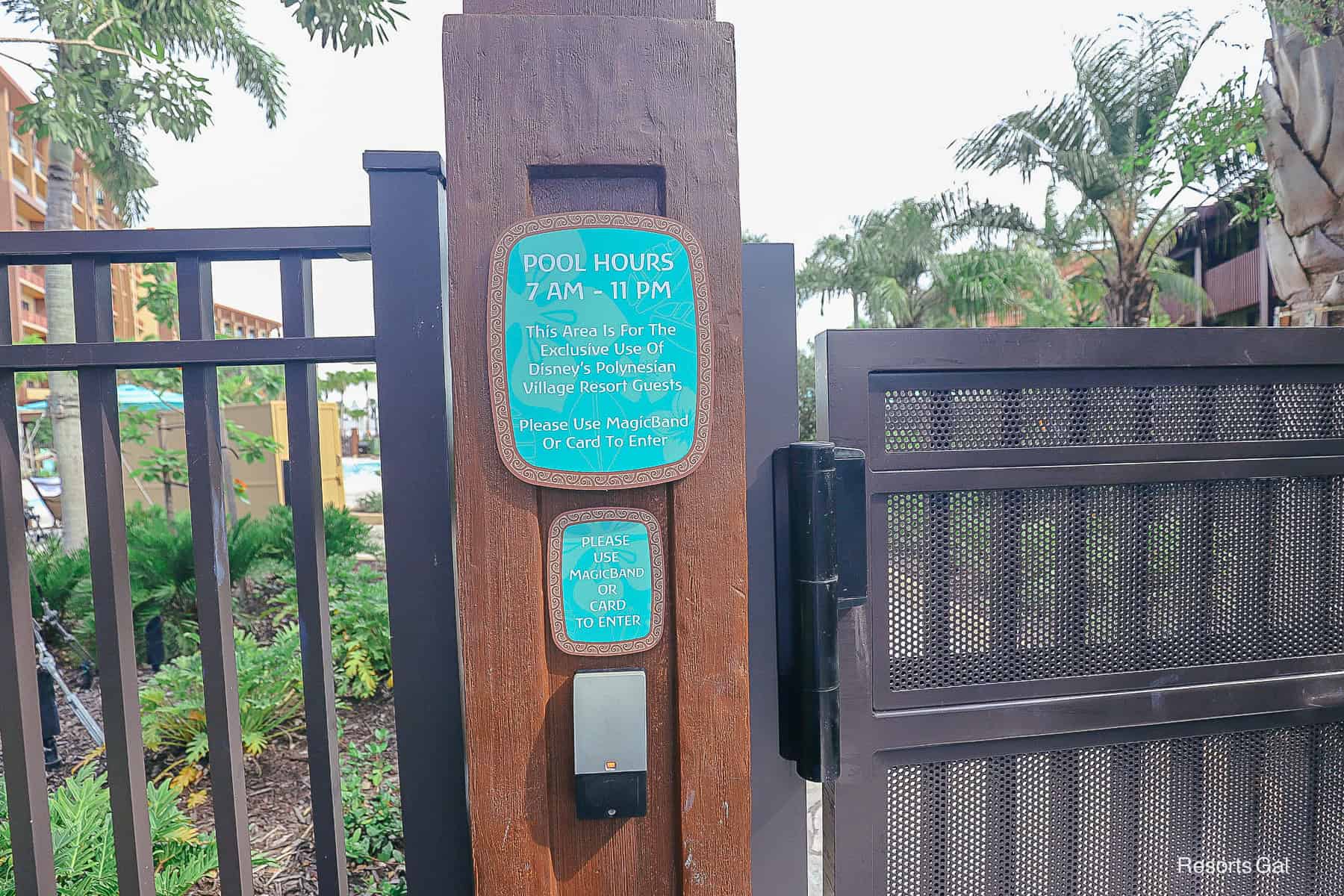 a magic band reader with a sign saying the pool is exclusive to resort guests 