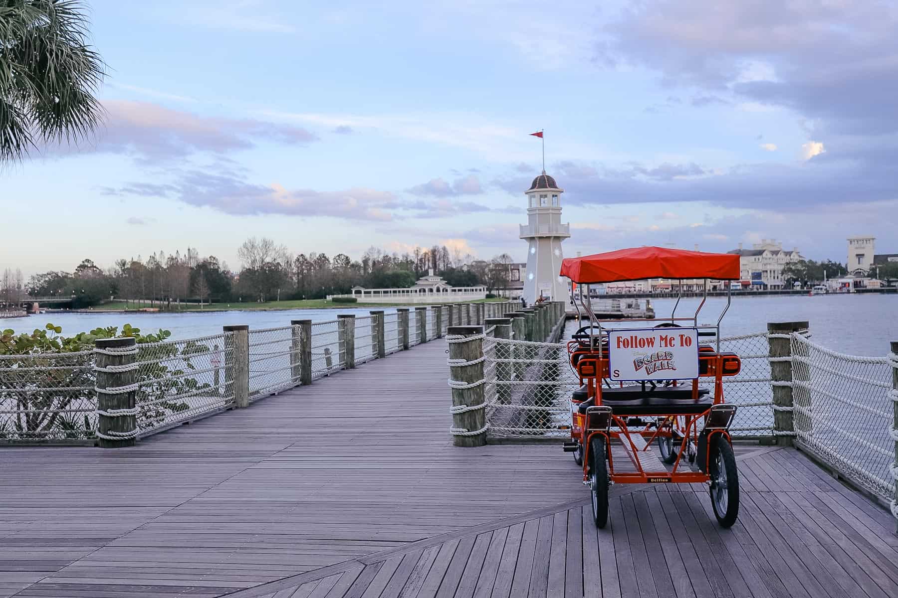 A Surrey bike parked in front of the lighthouse near the Yacht Club. 