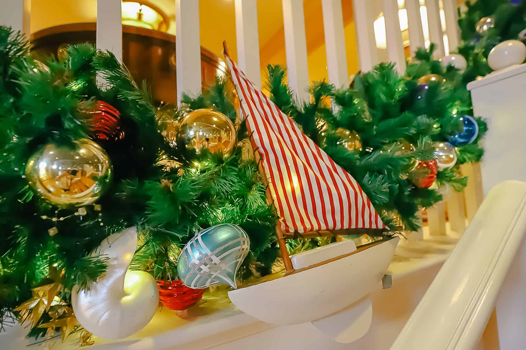 a decorative boat with a red and white striped sail 