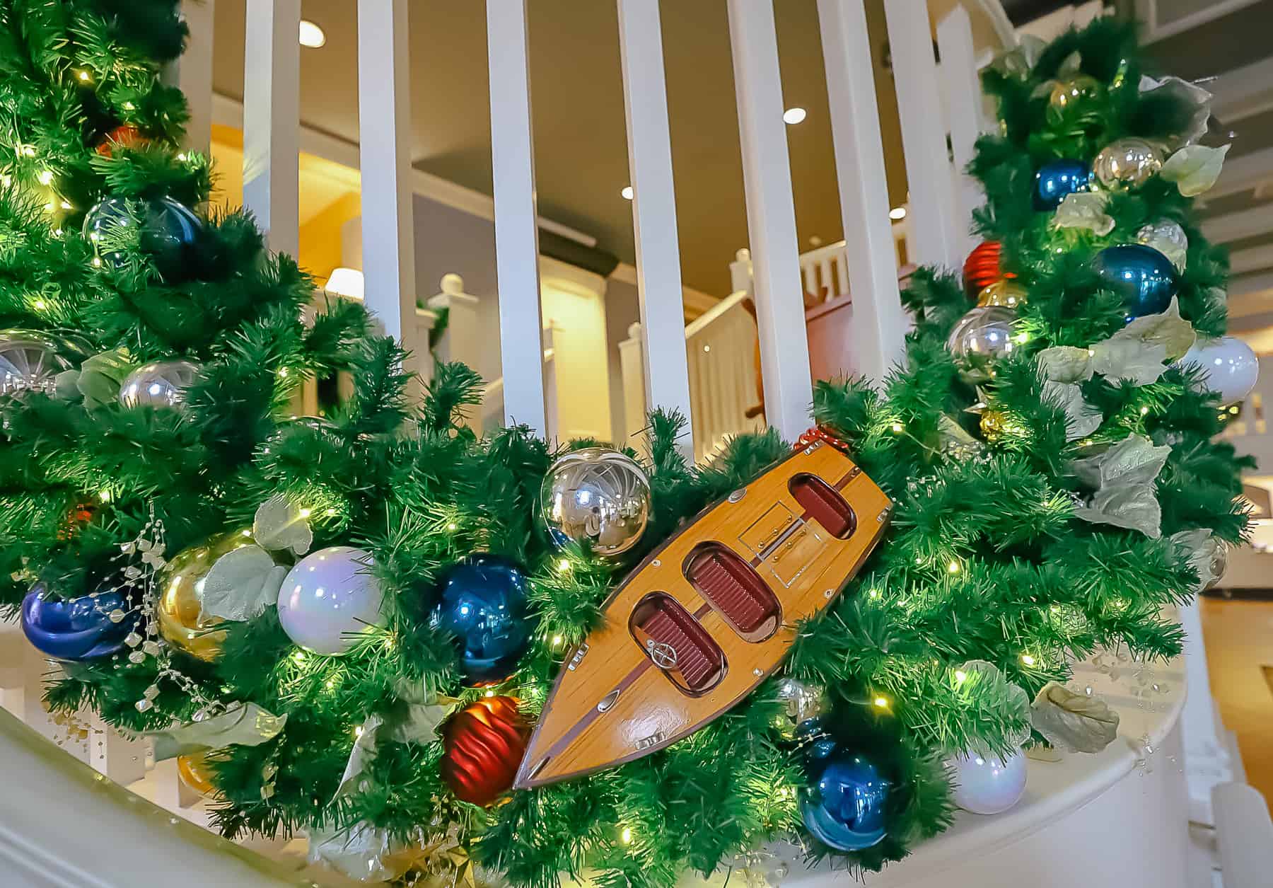 a boat in decorative garland wrapped around the railings 