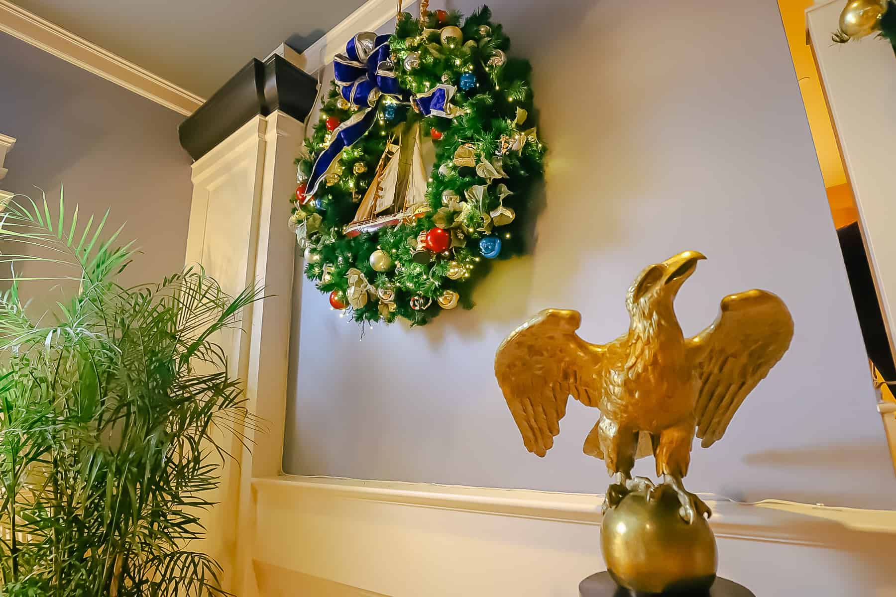 a statue of an eagle next to a Christmas wreath