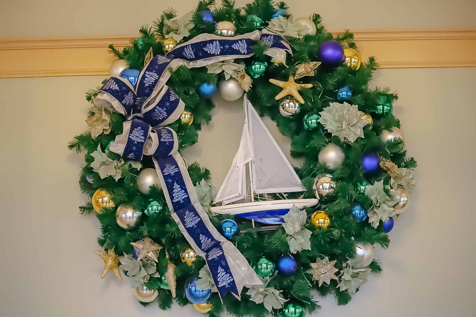 a wreath with stars, boats, and blue ribbon