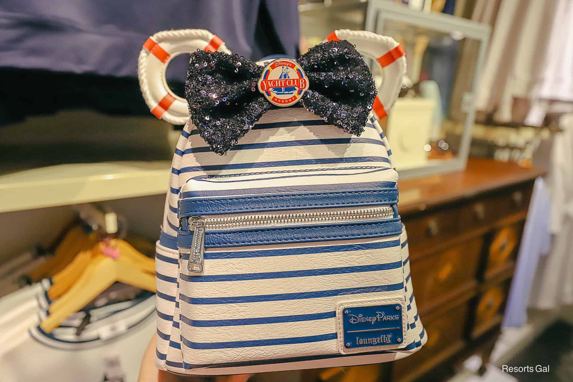 a blue striped Loungefly backpack representing Disney's Yacht Club