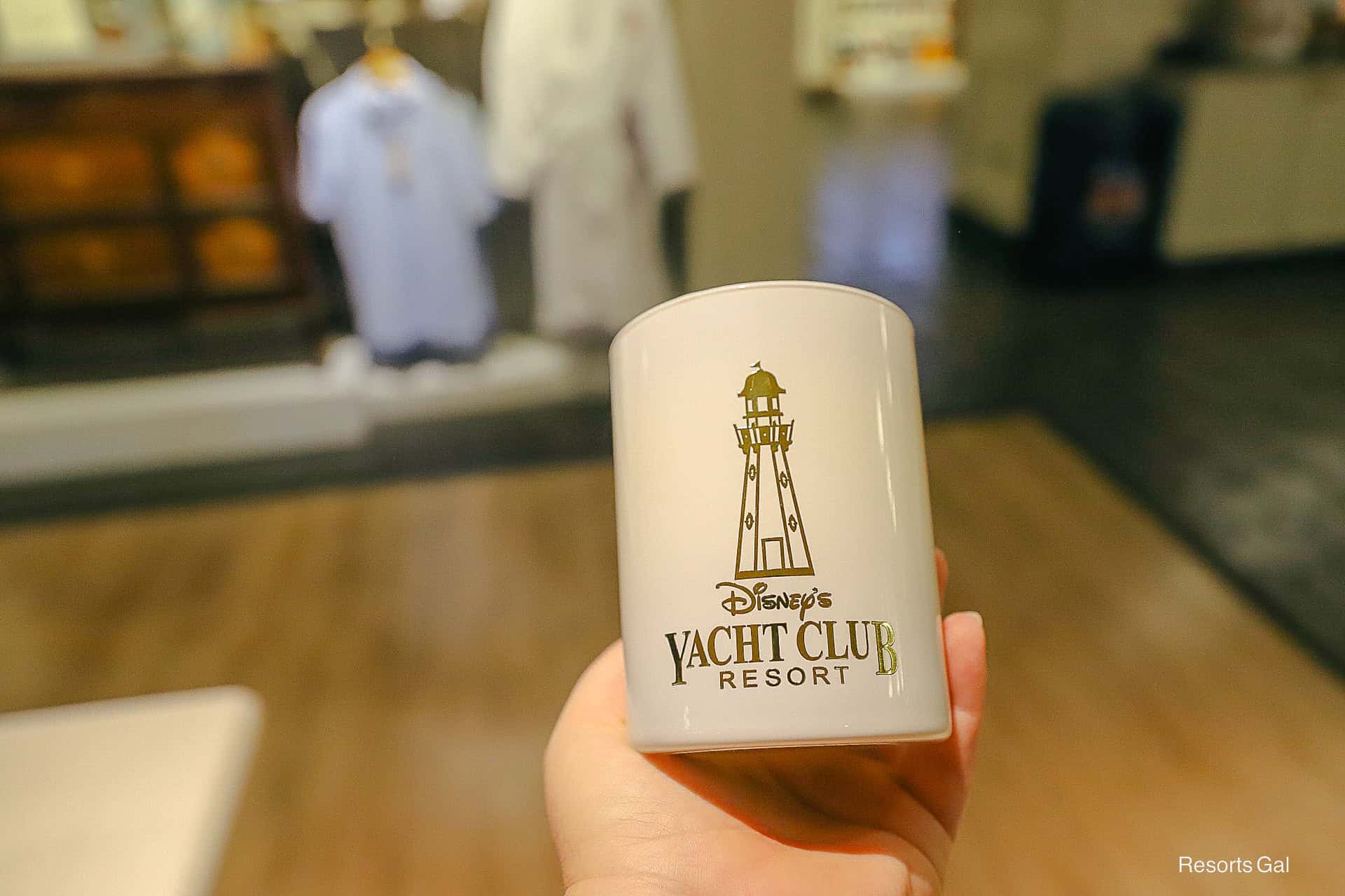 a candle with the Yacht Club's logo