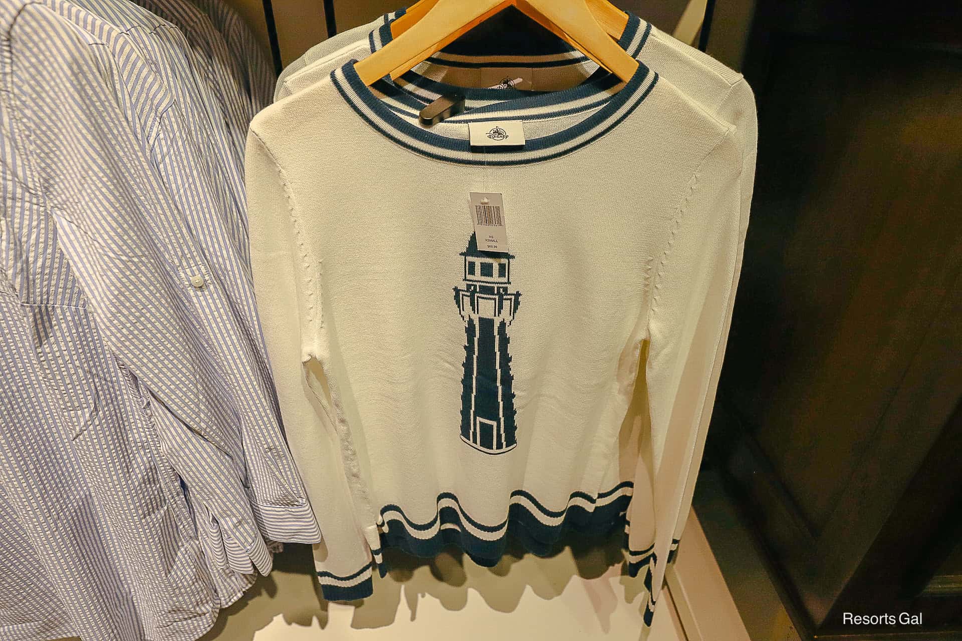 a Yacht Club Resort sweater with a lighthouse in white and navy blue