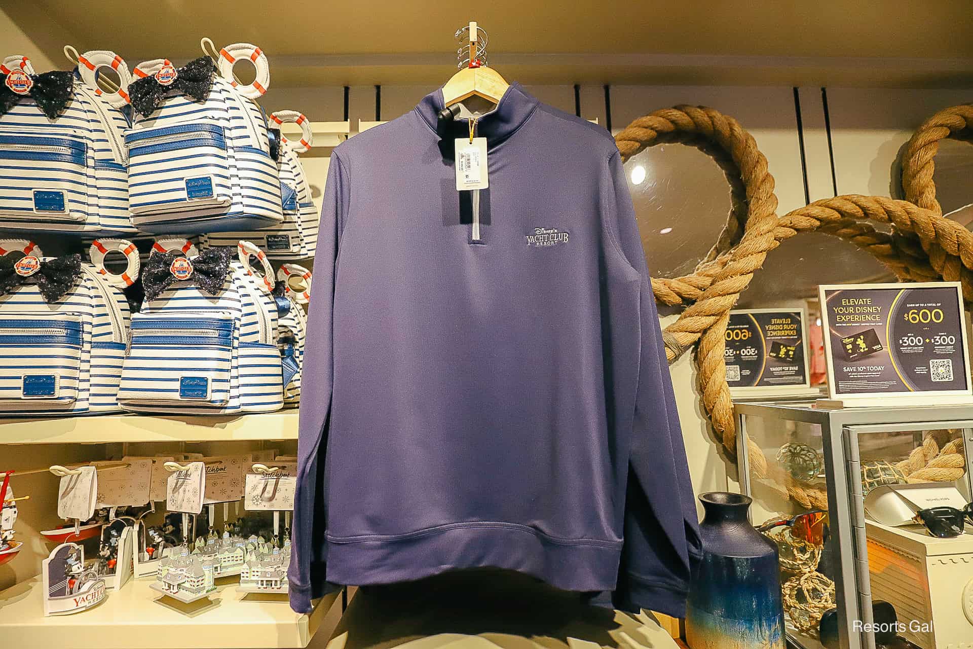 a blue partial zip up pullover by Peter Miller with the Yacht Club's logo