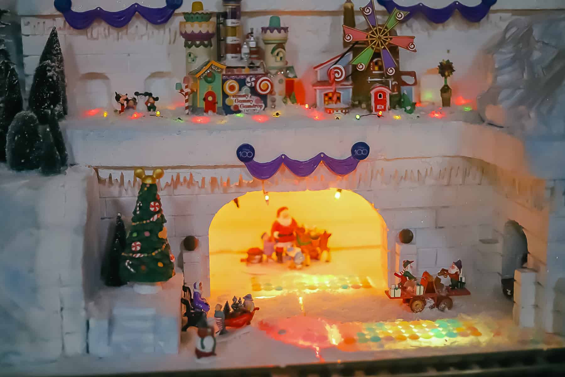 Santa sits at the base of the Christmas Village. 