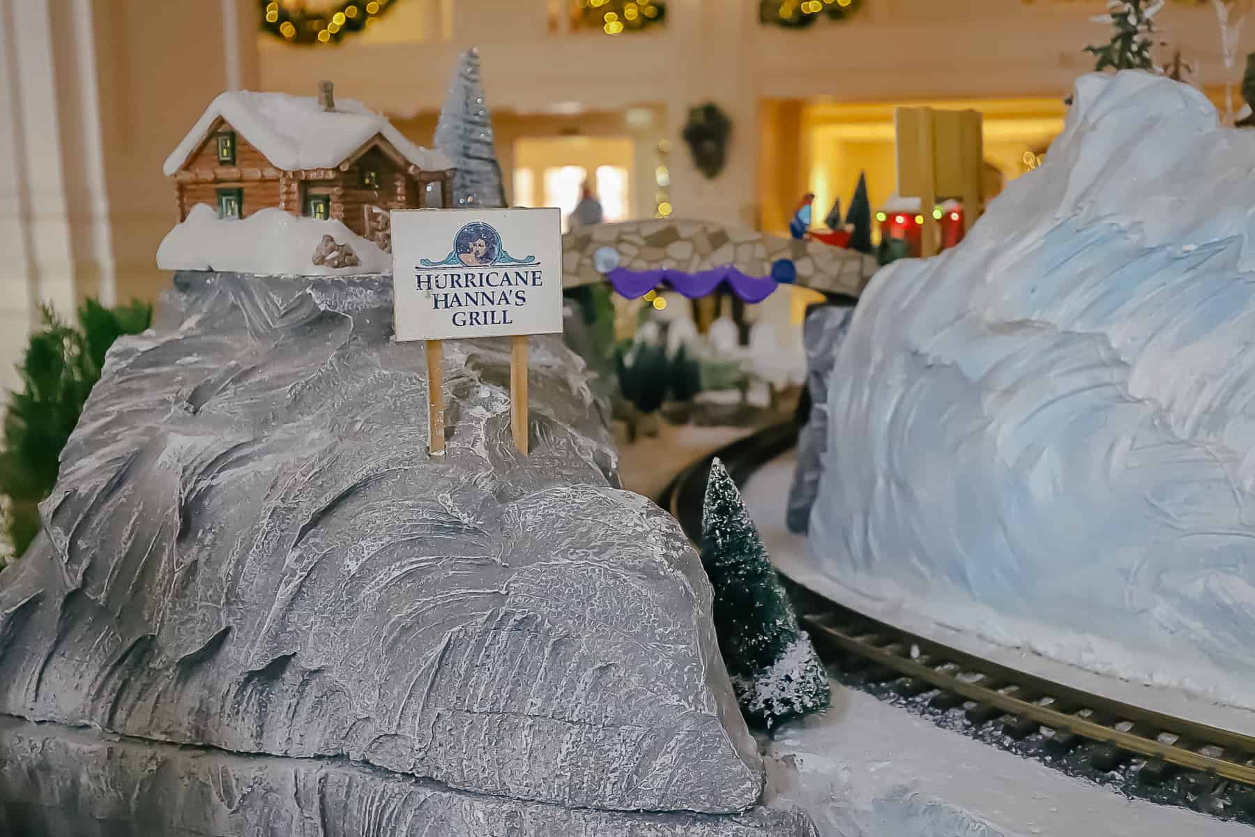 A miniature sign on the Christmas Village that says Hurricane Hanna's Grill. 