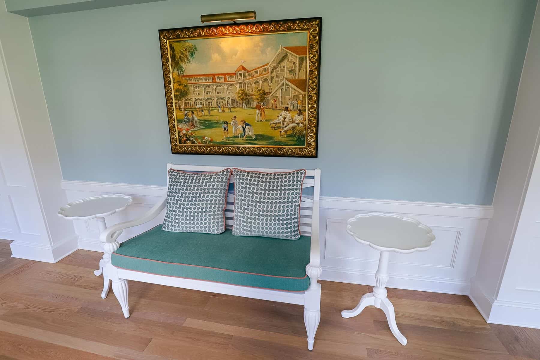 a bench for two with a painting above it 