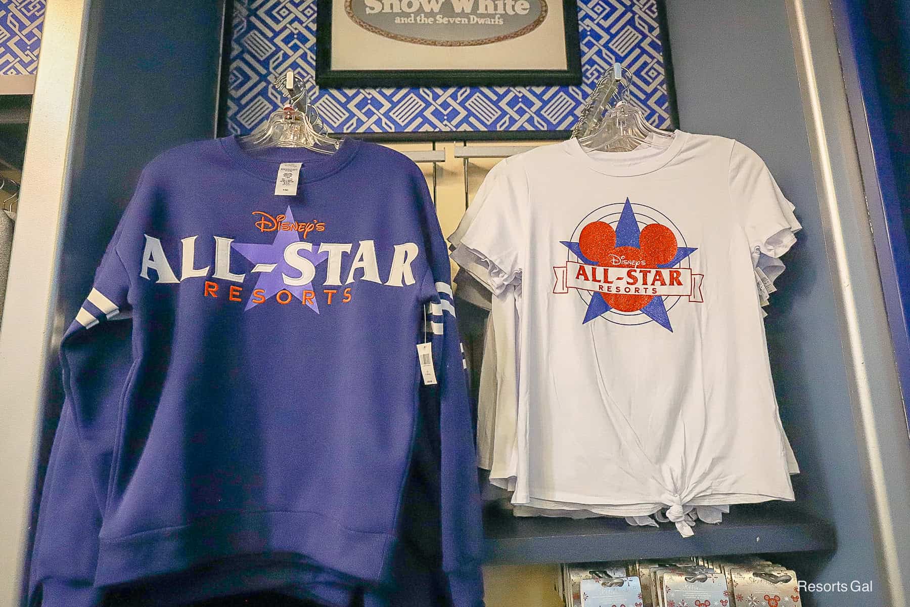 a blue sweatshirt and a white tie t-shirt both have the Disney's All-Star Resort logos 