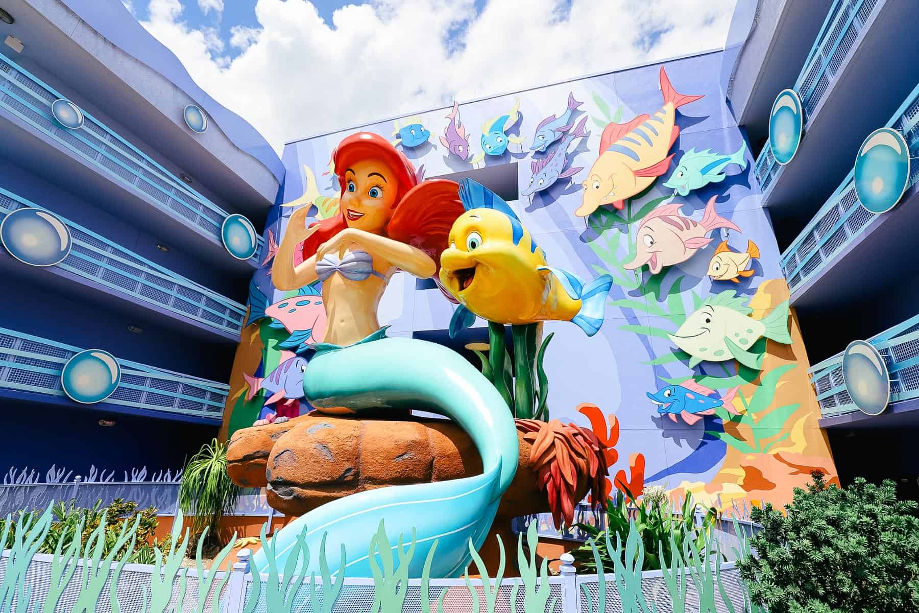 a statue with Ariel the Little Mermaid and Flounder at Art of Animation Resort 