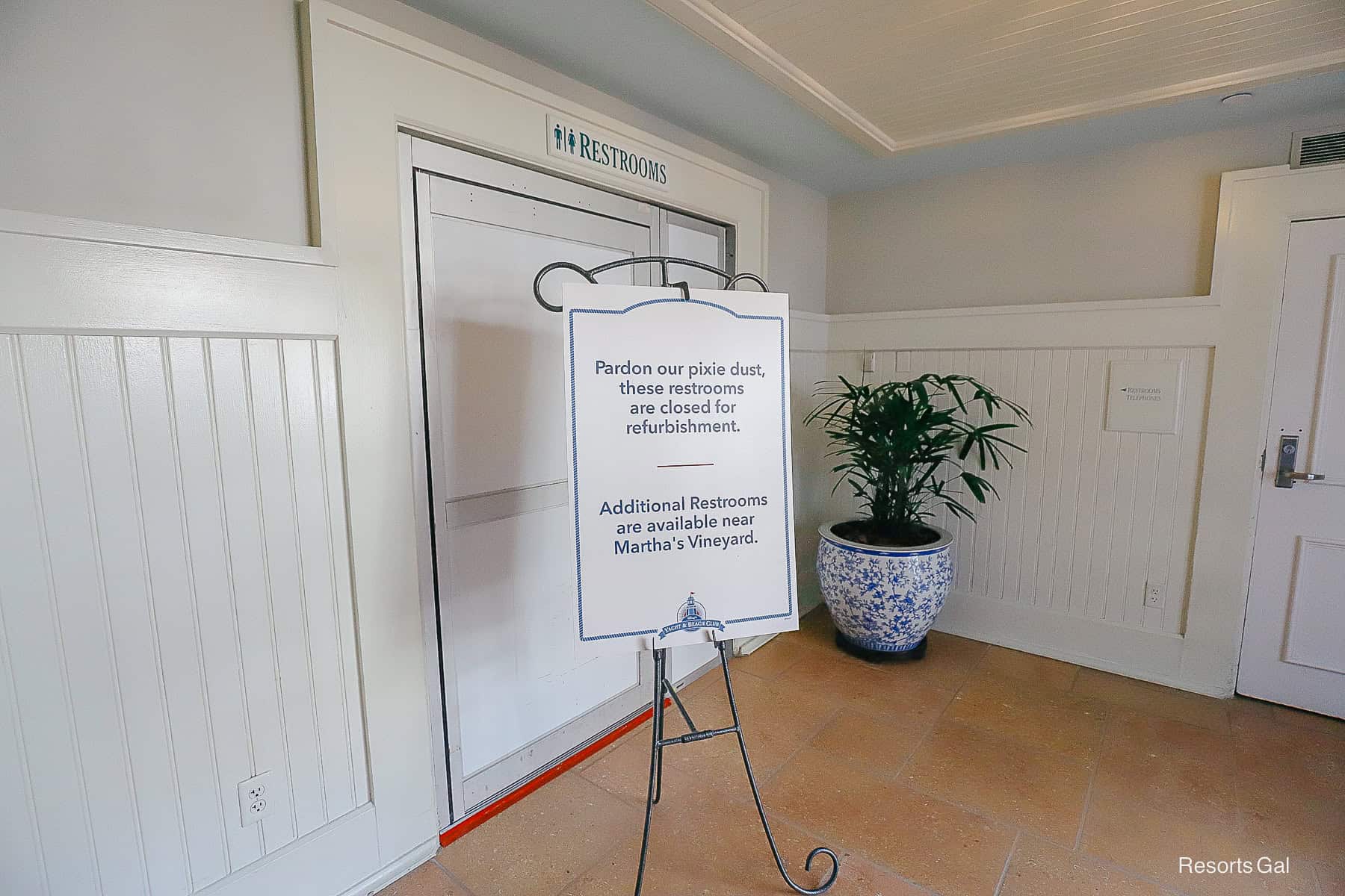 a sign saying the Beach Club's restrooms next to the gift shop are closed