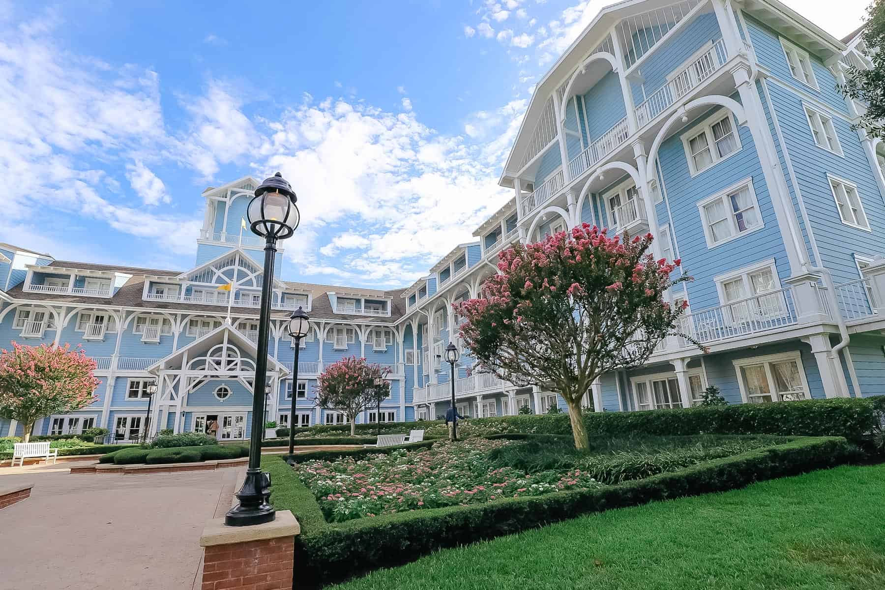 A side angle of the lobby entrance that shows the pink crepe myrtles in bloom. 