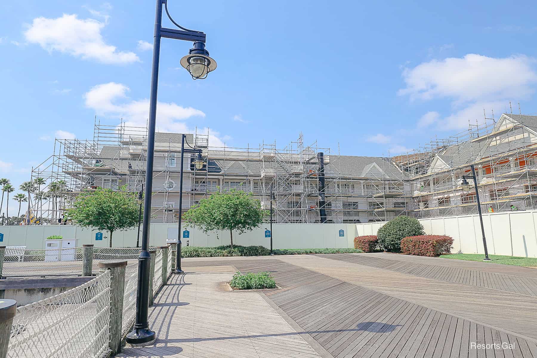 a long fence surrounding a large area of Disney's Yacht Club