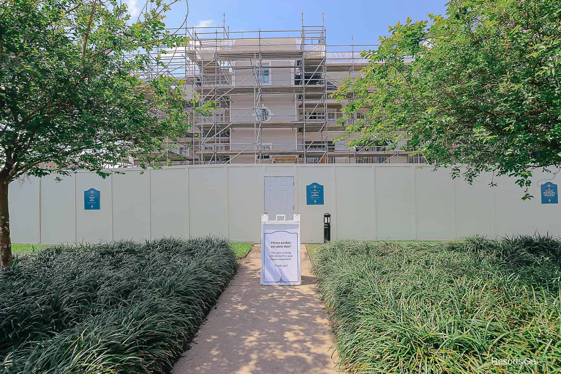 a fence with a sign that says Pardon Our Pixie Dust at Disney's Yacht Club
