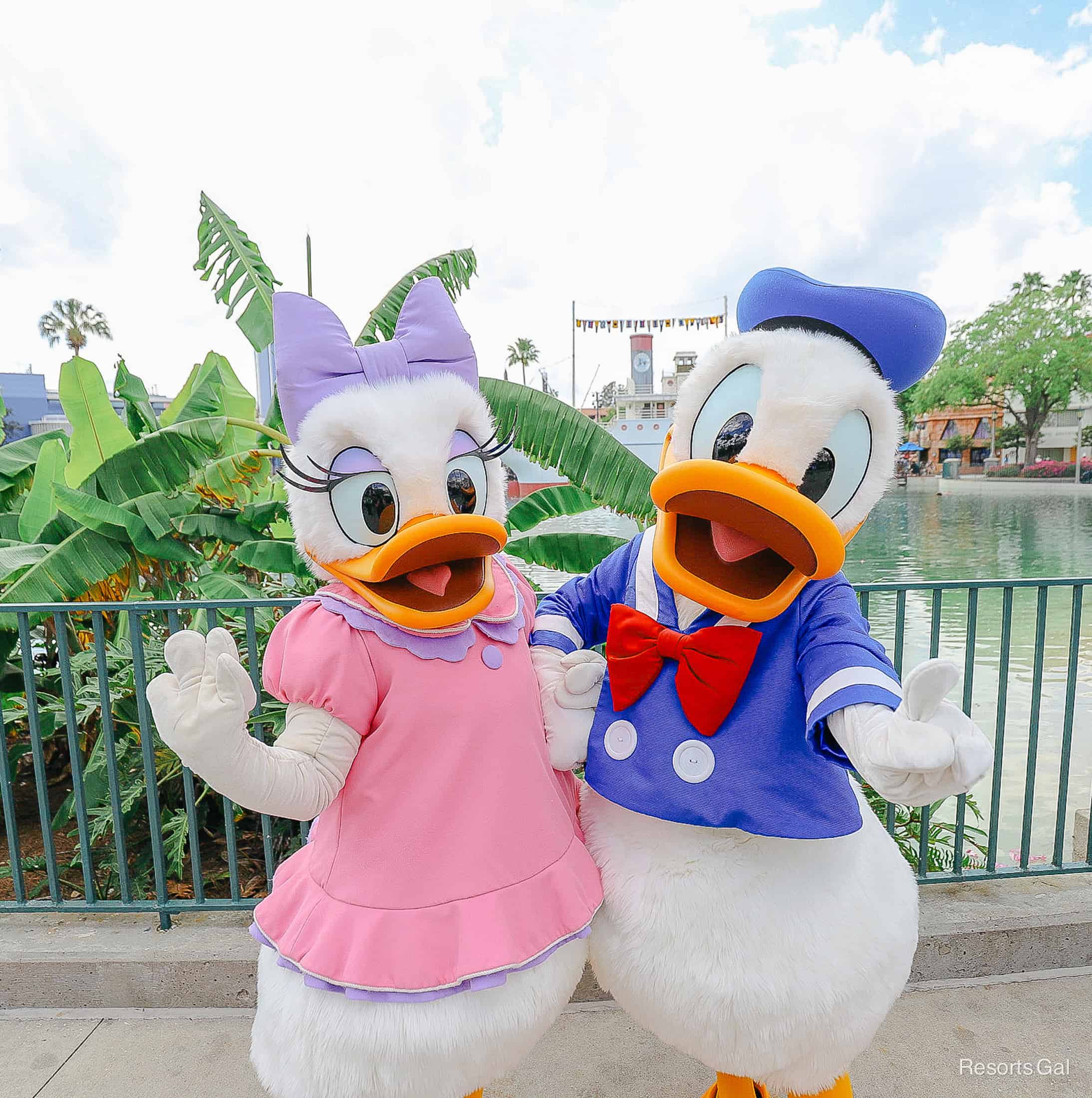 Donald poses with his number one and Daisy smiles. 