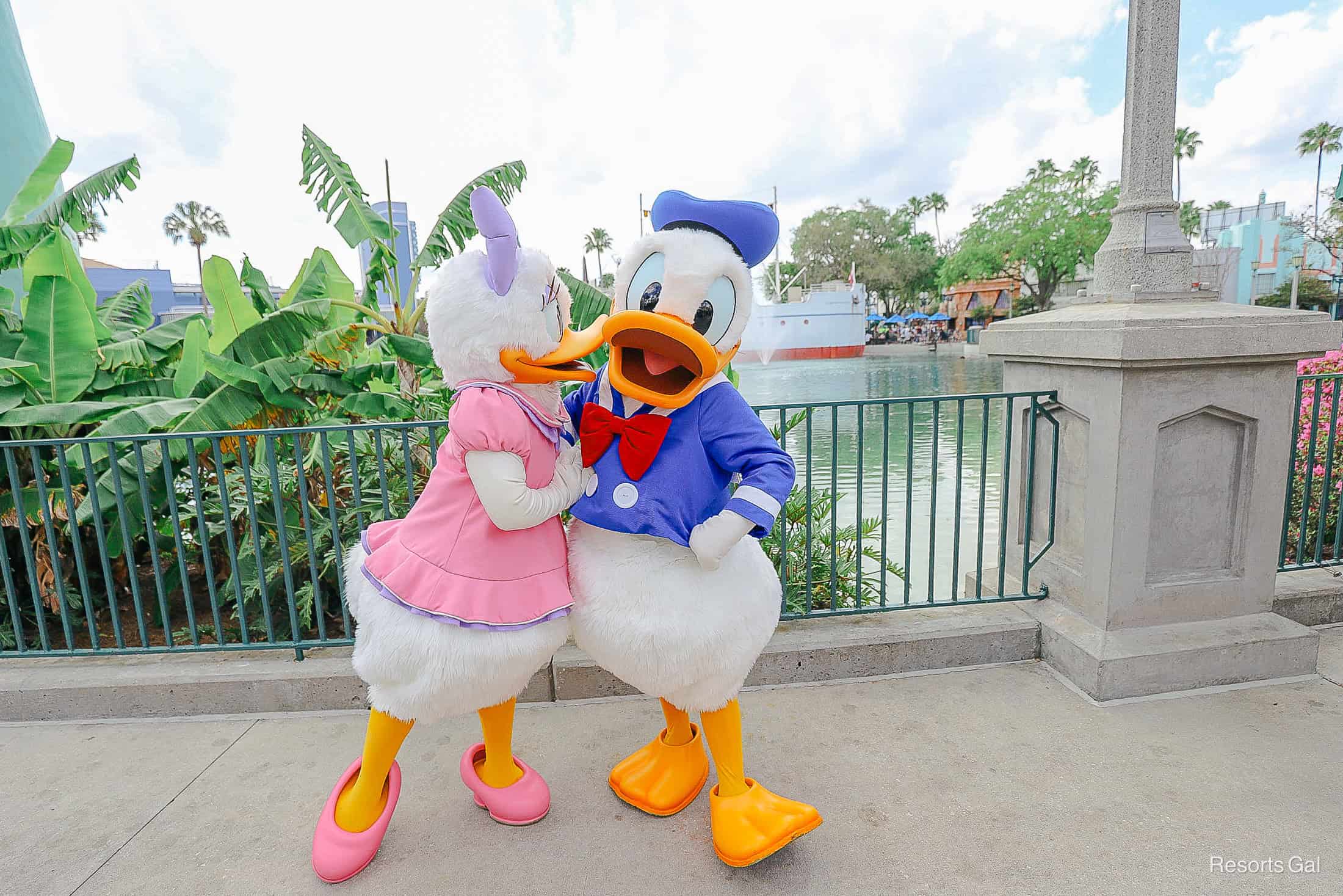 Daisy leans in to give Donald a kiss on the sheet. 