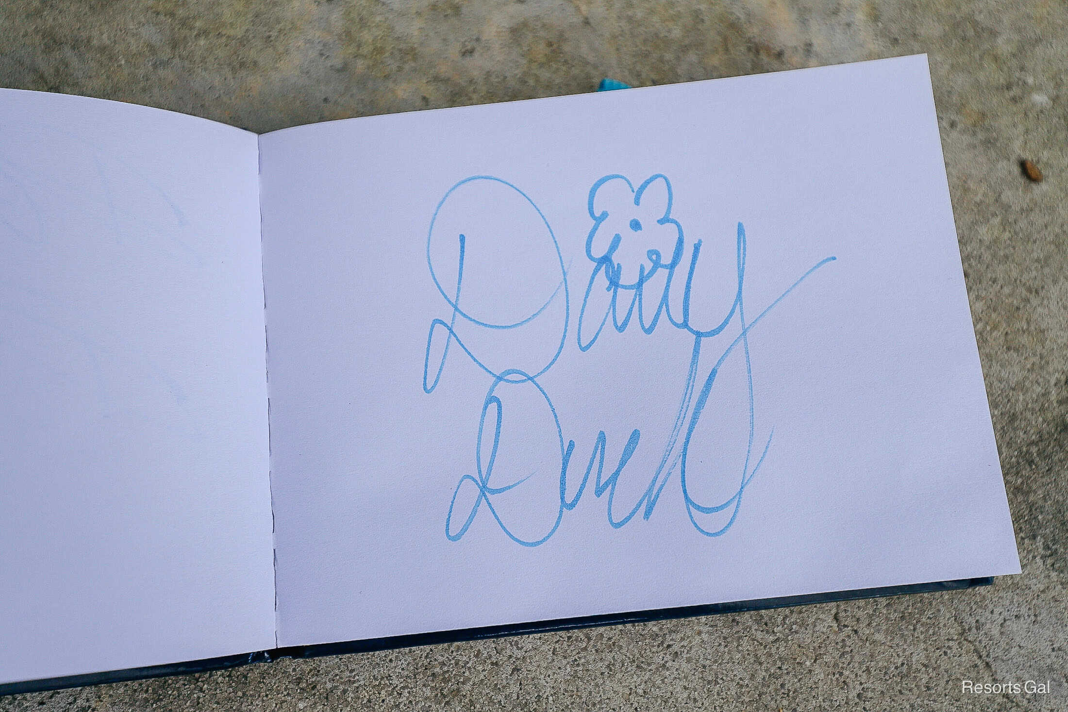 Daisy Duck's autograph with a flower to dot her "i'