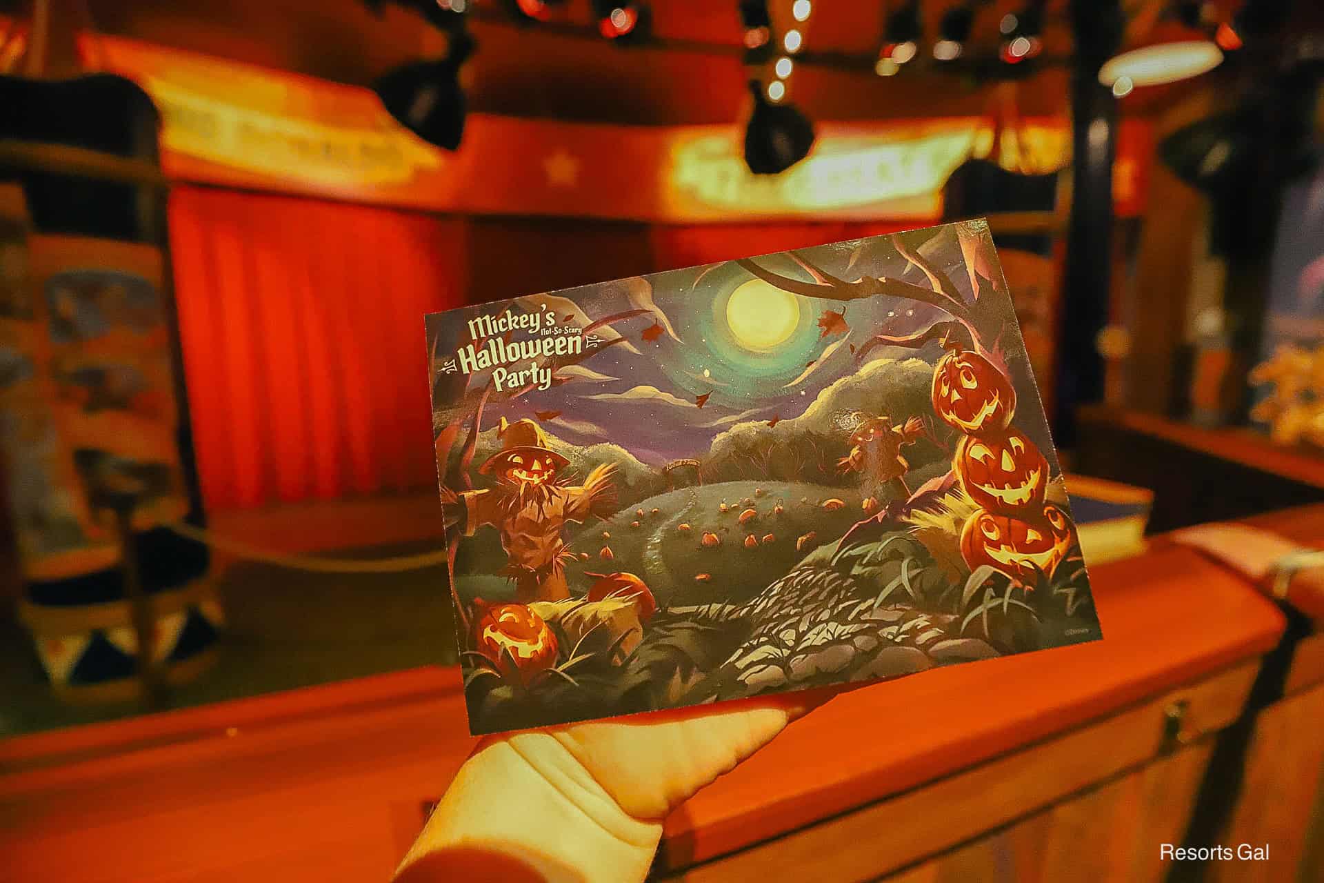 front of the autograph card is the backdrop of Donald and Daisy's meet-and-greet at the Halloween Party 