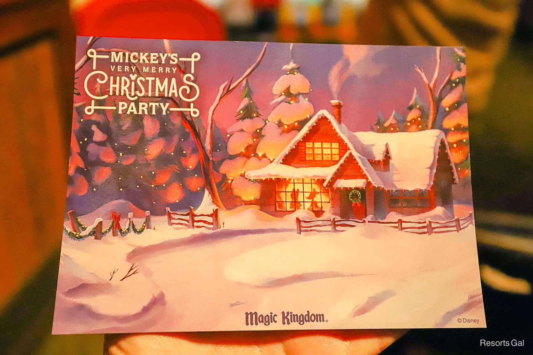 the front of the autograph card says Mickey's Very Merry Christmas Party with a cabin snow scene 