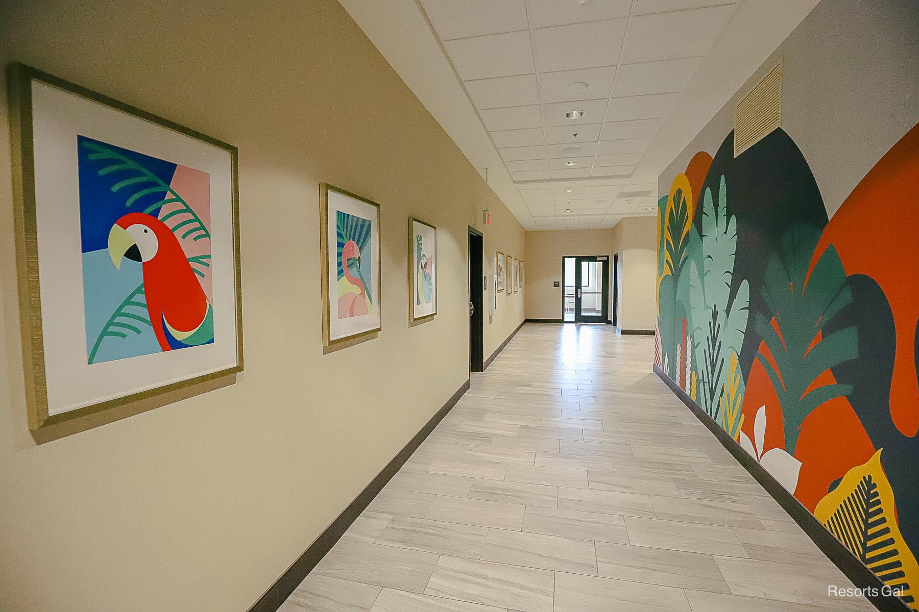 Hallway with bright, cheerful murals of tropical animals. 