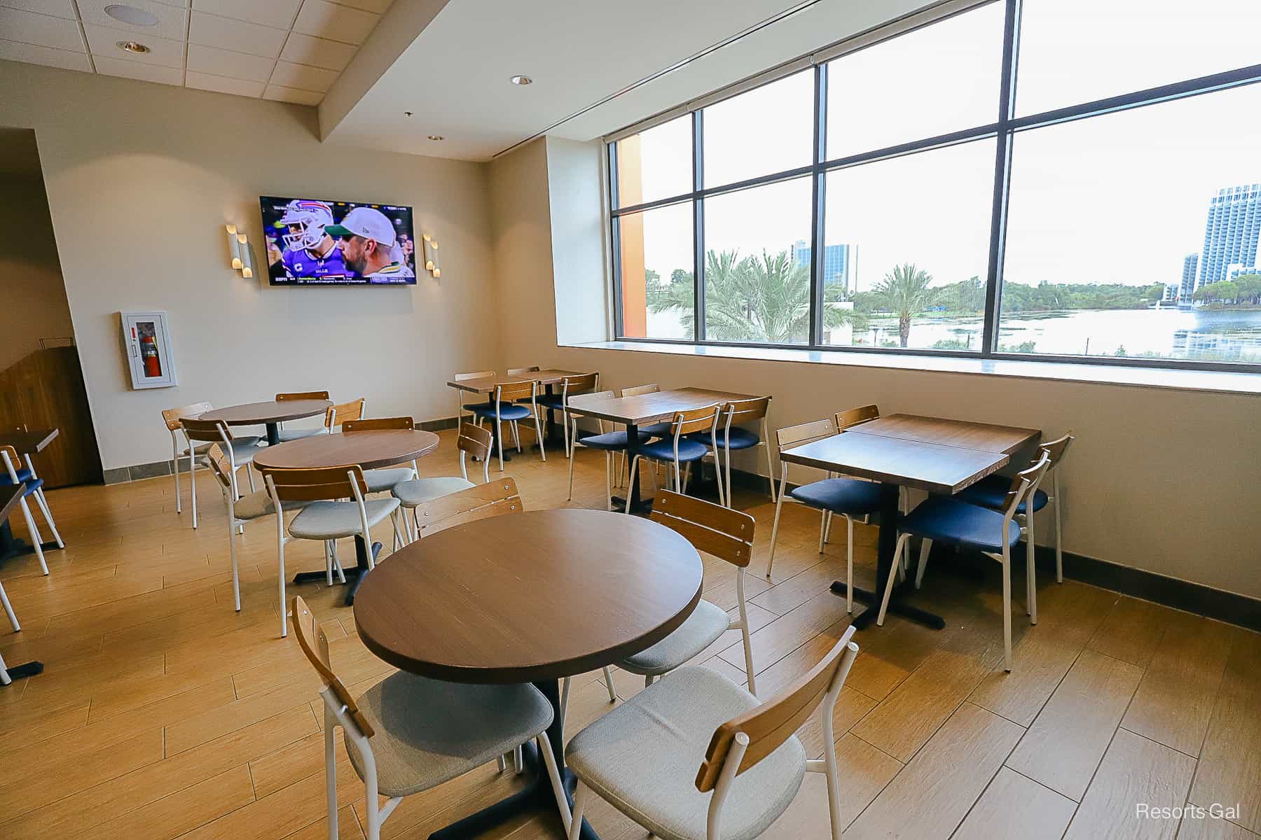 Tables with chairs facing a television 