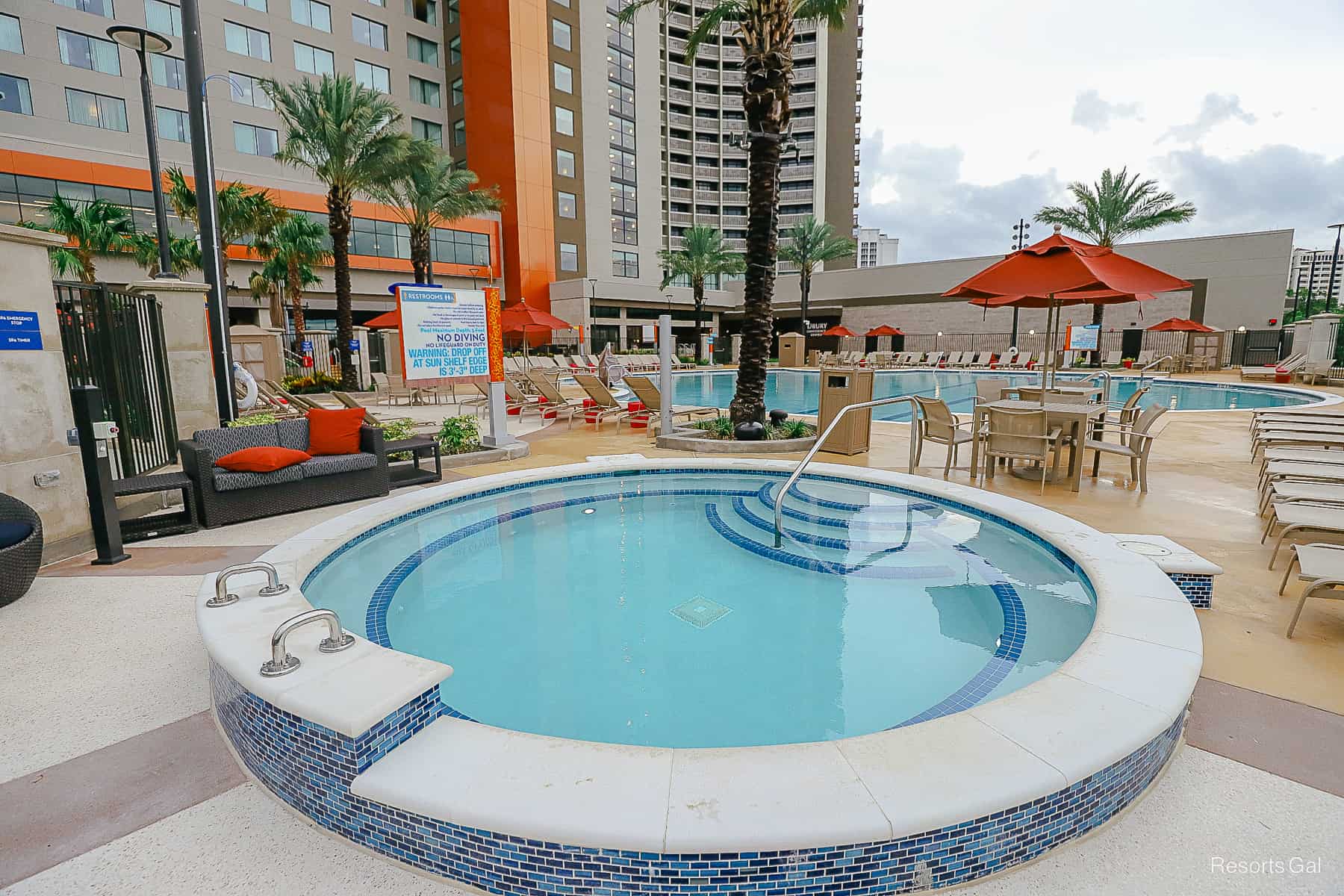 A hot tub with pretty mosaic tile around it. 