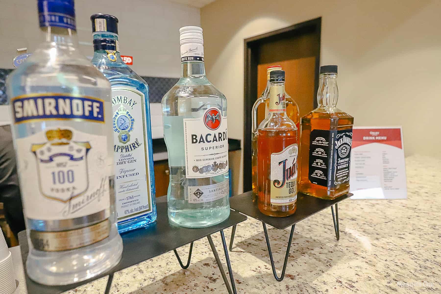 Various liquors sitting on the counter that are used for cocktails. 