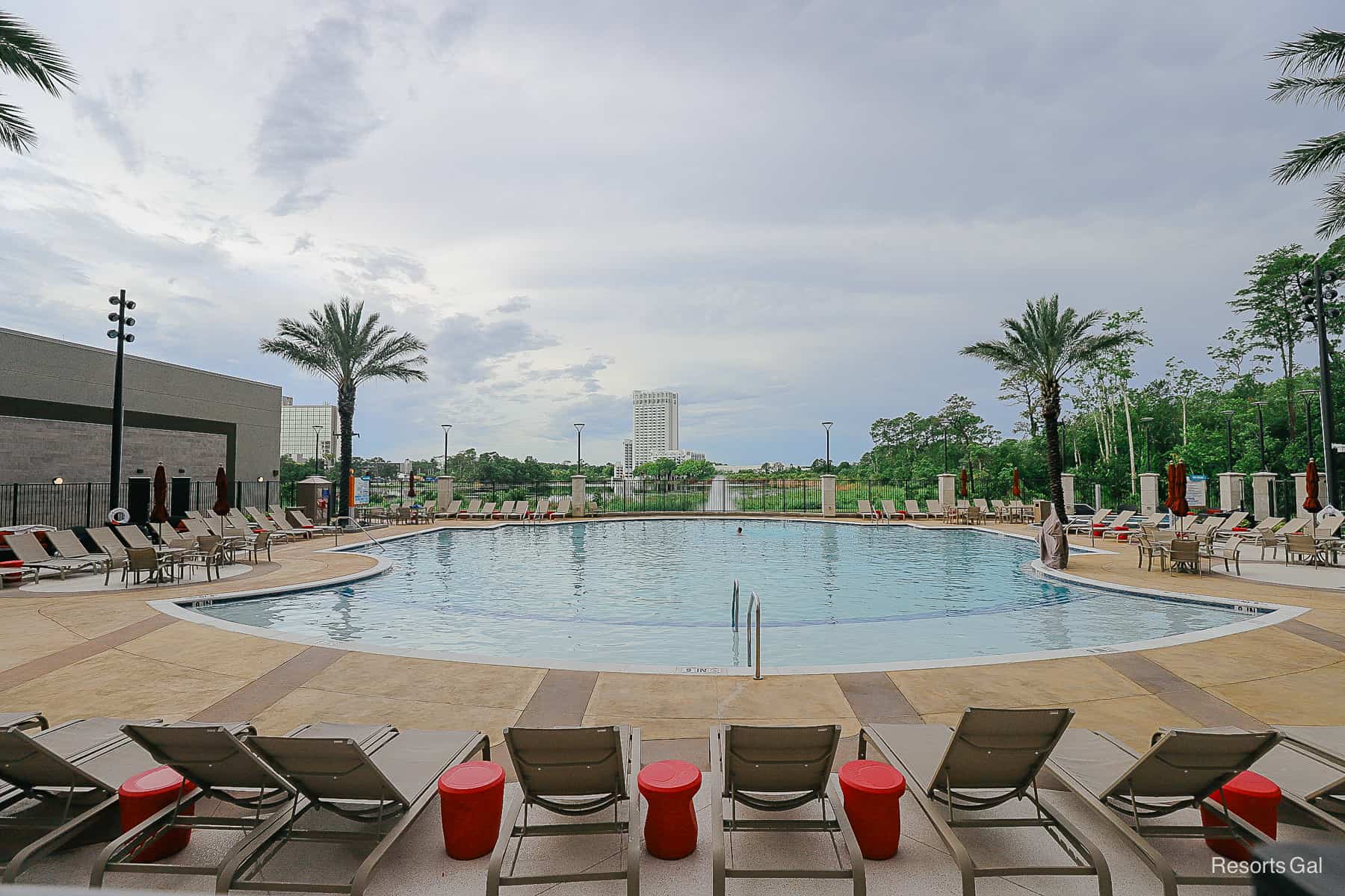 The pool faces a lake at the Drury Plaza Hotel at Disney Springs. 